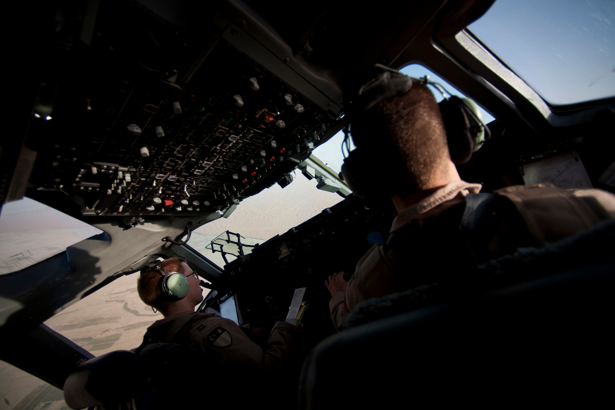 Capts. Matt Hammerle, left, and Eric Bowers, 817th Expeditionary Airlift Squadron pilots, takeoff in a C-17 Globemaster III aircraft Aug. 18, 2011, at Kandahar Air Field, Afghanistan. The crew transported equipment and supplies from Incirlik Air Base, Turkey. (U.S. Air Force photo by Tech. Sgt. Michael B. Keller/Released)