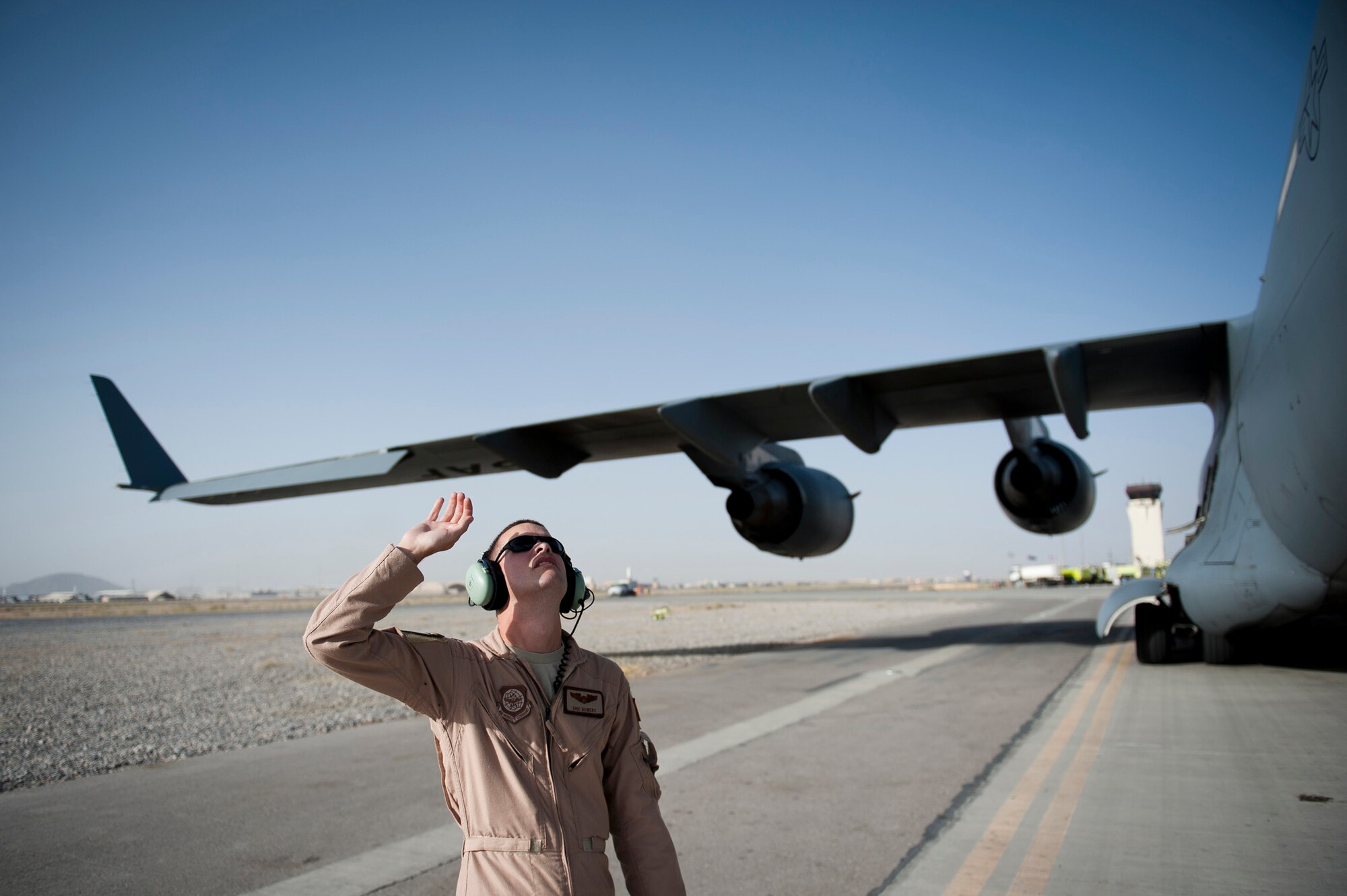 Capt. Eric Bowers, an 817th Expeditionary Airlift Squadron pilot, inspects a Globemaster III aircraft Aug. 18, 2011, before a flight at Kandahar Air Field, Afghanistan. The crew transported equipment and supplies from Incirlik Air Base, Turkey. (U.S. Air Force photo by Tech. Sgt. Michael B. Keller/Released)