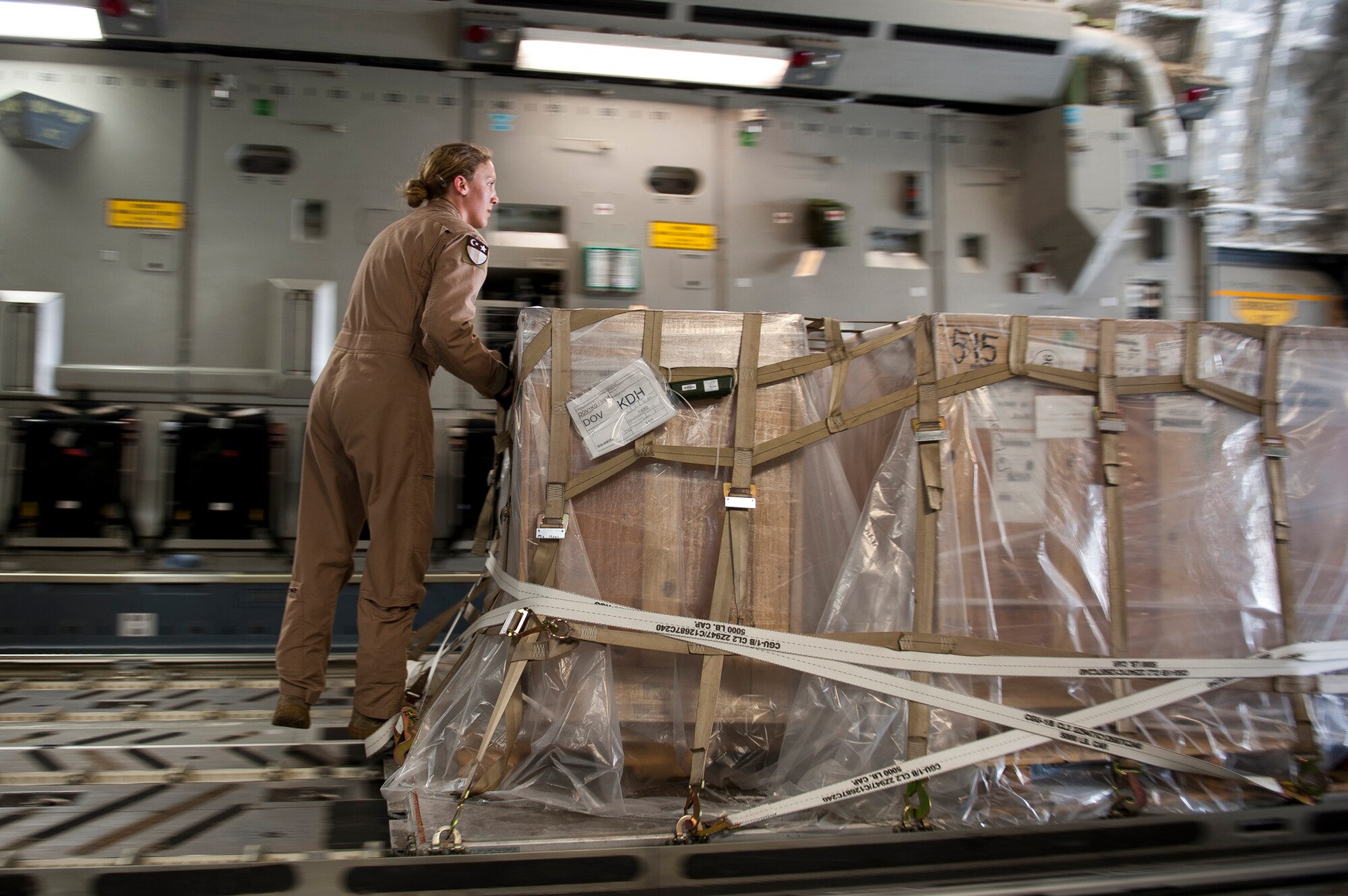 Staff Sgt. Melissa Butterfield, an 817th Expeditionary Airlift Squadron loadmaster, pushes a pallet of cargo while unloading a C-17 Globemaster III aircraft Aug. 18, 2011, at Kandahar Air Field, Afghanistan, during a mission to transport equipment and supplies from Incirlik Air Base, Turkey. Loadmasters not only ensure the cargo is properly secured during flight, but also help with the unloading. (U.S. Air Force photo by Tech. Sgt. Michael B. Keller/Released)