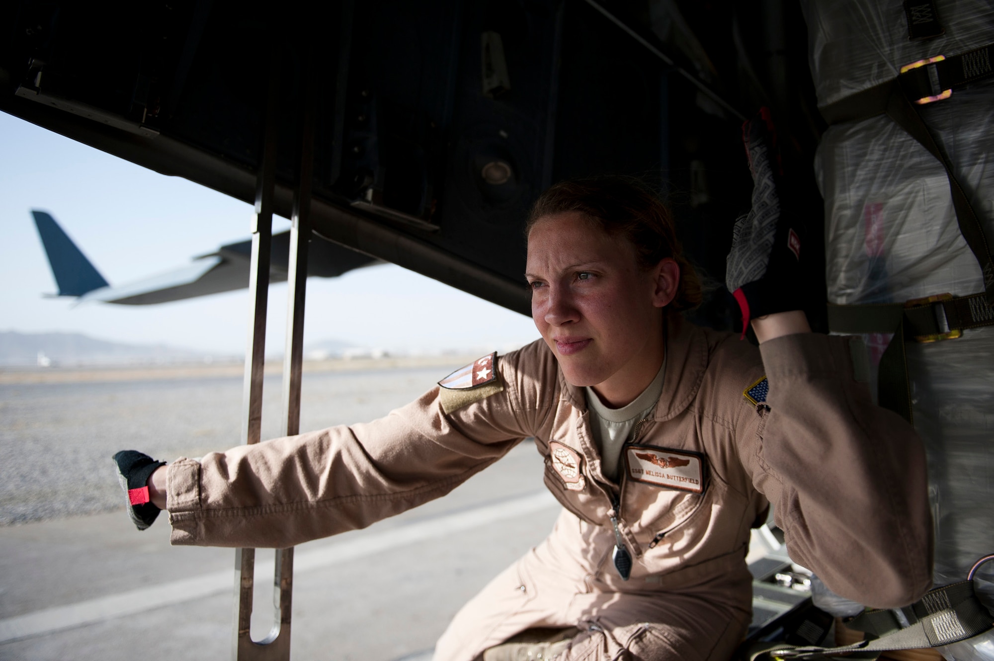 Staff Sgt. Melissa Butterfield, an 817th Expeditionary Airlift Squadron loadmaster, directs equipment to unload a C-17 Globemaster III aircraft Aug. 18, 2011, at Kandahar Air Field, Afghanistan, during a mission to transport equipment and supplies from Incirlik Air Base, Turkey. Loadmasters not only ensure the cargo is properly secured during flight, but also help with the unloading. (U.S. Air Force photo by Tech. Sgt. Michael B. Keller/Released)