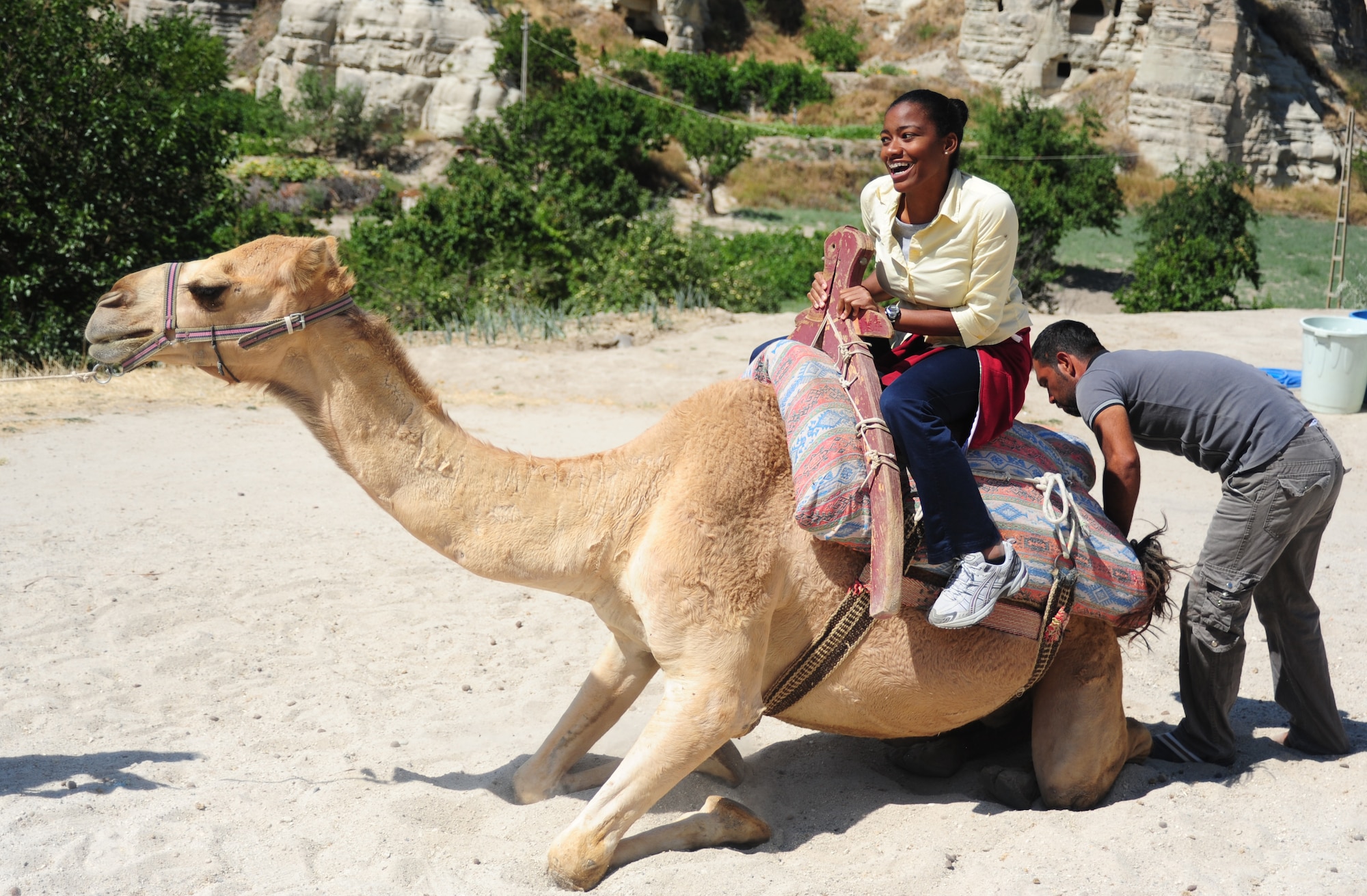 Crystal Harris, 728th Air Mobility Squadron field engineering and technical support technician, takes a camel ride as part of a base tour Aug. 13, 2011, at Cappadocia, Turkey.  The camel rides were given to any who wished to participate at the end of the Goreme Open-Air Museum. (U.S. Air Force photo by Senior Airman Anthony Sanchelli/Released) 