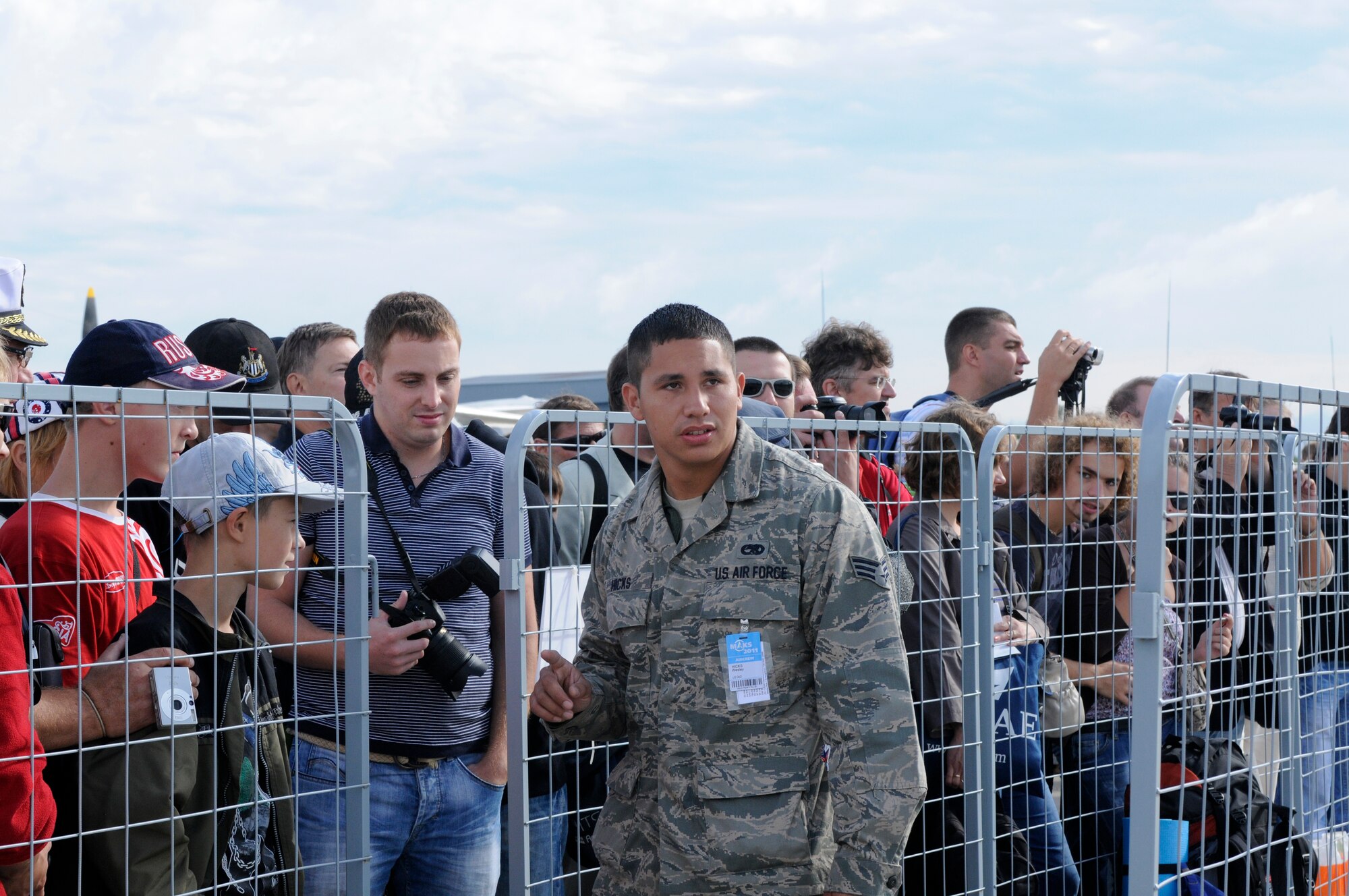 ZHUKOVSKY AIR FIELD, Russia – Senior Airman Wesley Hicks, 492nd Fighter Squadron crew chief from Royal Air Force Lakenheath, pulls security and crowd control at the U.S. chorale here Aug. 19 during the Moscow International Aviation and Space Salon, or MAKS 2011. MAKS is one of the premier events of its type in the world and Department of Defense participation demonstrates the United States commitment to international security, promotes international cooperation, and contributes to U.S. foreign policy objectives.  The U.S. Air Force has a KC-10 Extender, two F-16C Fighting Falcons, two A-10 Thunderbolt II, one F-15E Strike Eagle, one B-52 Stratotanker, C-130J Super Hercules and C-5M Galaxy statics for the show. (U.S. Air Force photo/Master Sgt. Kelley J. Stewart)