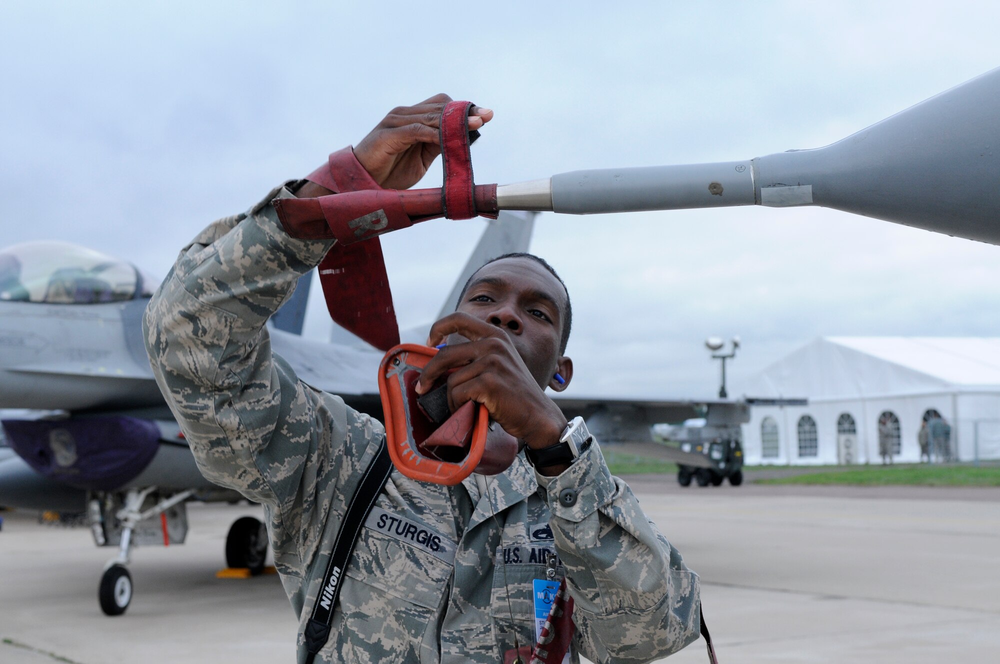 ZHUKOVSKY AIR FIELD, Russia – Staff Sgt. James Sturgis, 510th Fighter Squadron crew chief from Aviano Air Base, Italy, removes the Pitot tube here Aug. 19 in preparation for the daily opening of the Moscow International Aviation and Space Salon, or MAKS 2011. MAKS is one of the premier events of its type in the world and Department of Defense participation demonstrates the United States commitment to international security, promotes international cooperation, and contributes to U.S. foreign policy objectives.  The U.S. Air Force has a KC-10 Extender, two F-16C Fighting Falcons, two A-10 Thunderbolt II, one F-15E Strike Eagle, one B-52 Stratotanker, C-130J Super Hercules and C-5M Galaxy statics for the show. (U.S. Air Force photo/Master Sgt. Kelley J. Stewart)