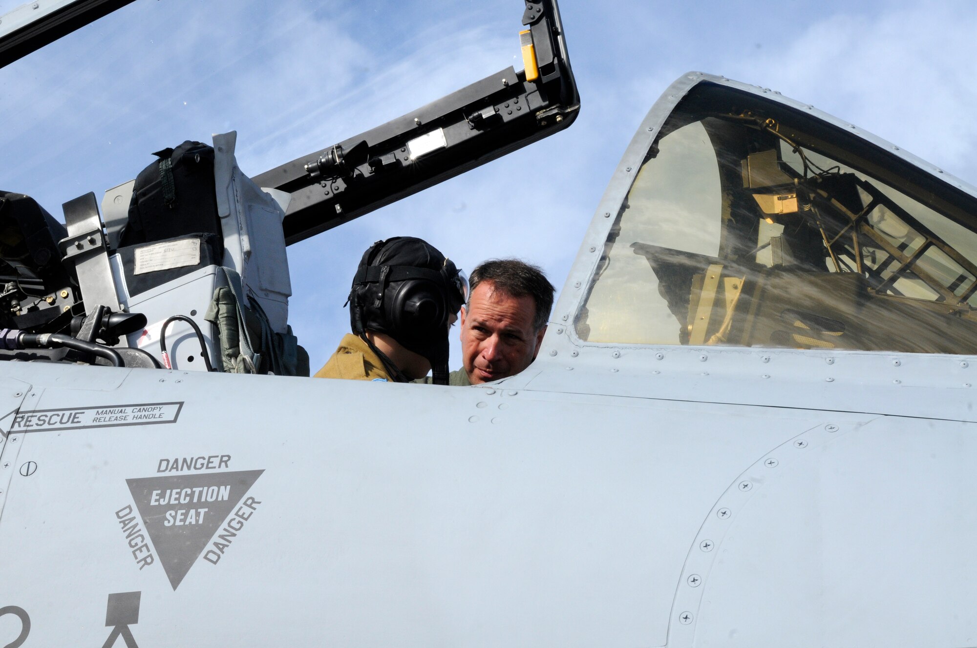 ZHUKOVSKY AIR FIELD, Russia -- Lt. Col. Douglas Sirk, 81st Fighter Squadron pilot from Spangdahlem Air Base, Germany, explains some of the switches in the cockpit of his A-10 Thunderbolt II, to Michael Anguladze, at the Moscow International Aviation and Space Salon, or MAKS 2011, here Aug. 19.  MAKS is one of the premier events of its type in the world and Department of Defense participation demonstrates the United States commitment to international security, promotes international cooperation, and contributes to U.S. foreign policy objectives.  The U.S. Air Force has a KC-10 Extender, two F-16C Fighting Falcons, two A-10 Thunderbolt II, one F-15E Strike Eagle, one B-52 Stratotanker, C-130J Super Hercules and C-5M Galaxy statics for the show. (U.S. Air Force photo/Master Sgt. Kelley J. Stewart)