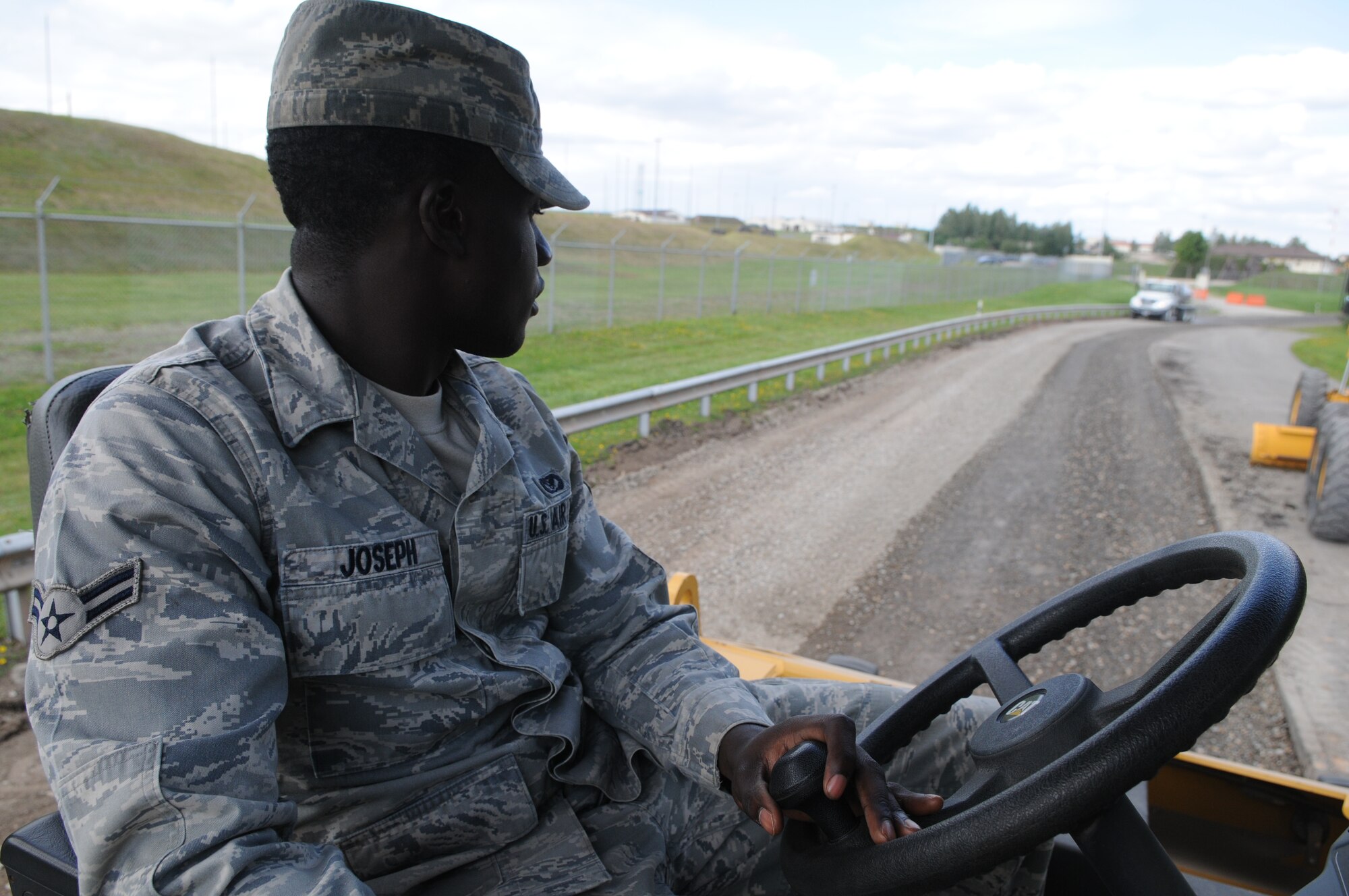 SPANGDAHLEM AIR BASE, Germany – Airman 1st Class Craig Joseph, 52nd Civil Engineer Squadron pavement and equipment journeyman, drives a steel-wheeled roller to smooth dirt in preparation for the pavement process here Aug 16. Pavement and equipment Airmen are combat engineers who engineers who train continuously to perform a variety of maintenance projects. The projects, which include airfield sweeping, road maintenance and snow removal, ensure Sabers and their families can drive safely on base. (U.S. Air Force photo/Senior Airman Nick Wilson)