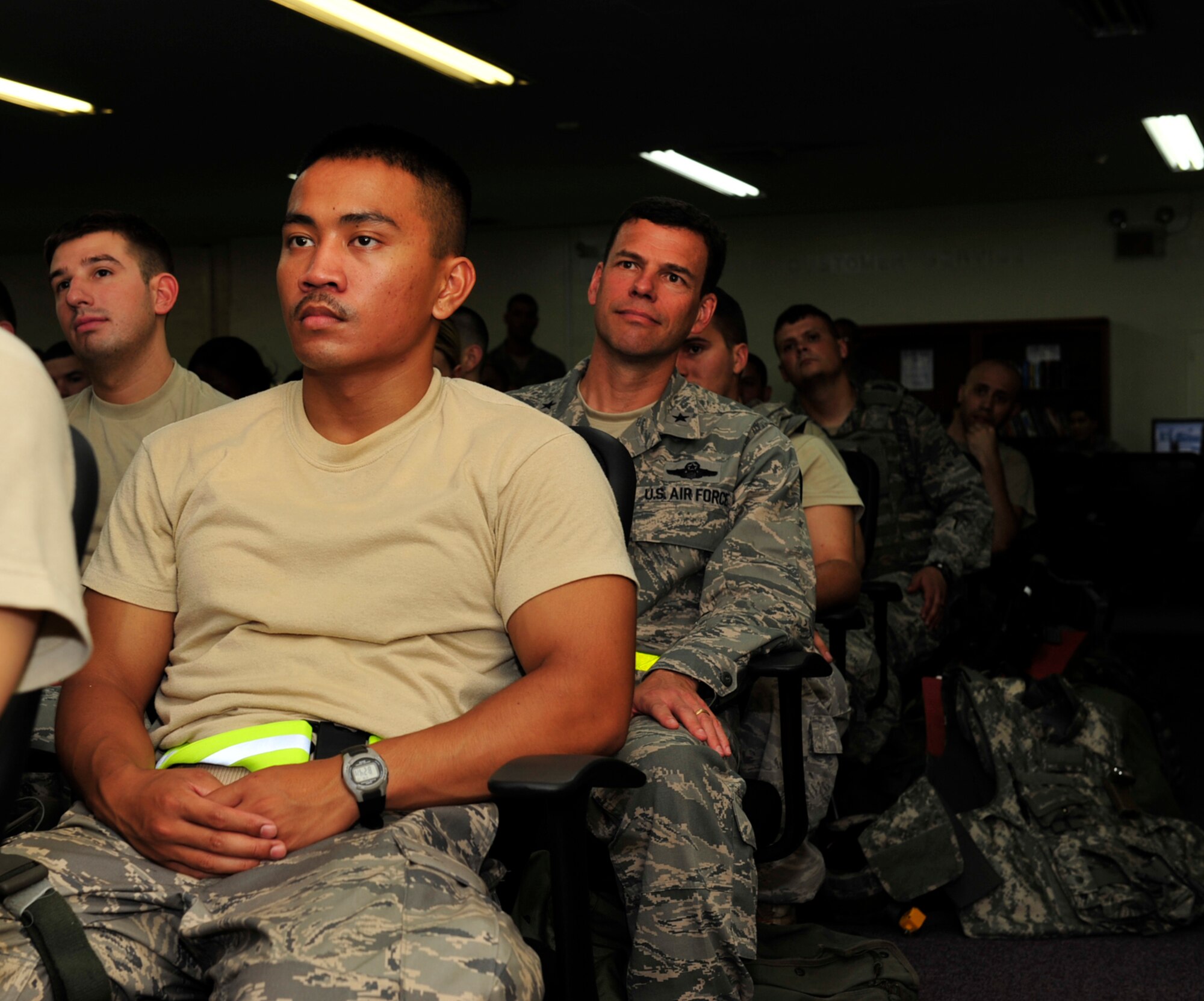 Brig. Gen. Matt Molloy (center), 18th Wing commander, receives pre-deployment briefings along with members of the 18th Security Forces Squadron during a no-notice Operational Readiness Inspection at Kadena Air Base, Japan, Aug 19. The Pacific Air Force Inspector General team evaluated the 18th Wing on overall operational preparedness and combat capability. (U.S. Air Force photo/Staff Sgt. Lakisha A. Croley)