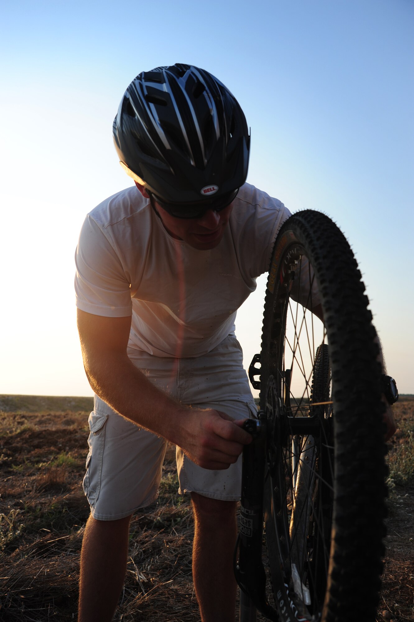 Staff Sgt. John Houseman, 728th Air Mobility Squadron cyber systems operations technician, unhooks his front tire before replacing a flat inner-tube during a bike club ride Aug. 17, 2011, near Incirlik Village, Turkey. Started in Korea in 2006, the Beer Belly Bike Club expanded to Incirlik, Turkey when co-founder Hector Contreras and Philip Hammond, the club’s current organizer, began riding together in the summer of 2009. In addition to Incirlik, three other European and several stateside chapters have been started. (U.S. Air Force photo by Senior Airman Anthony Sanchelli/Released) 