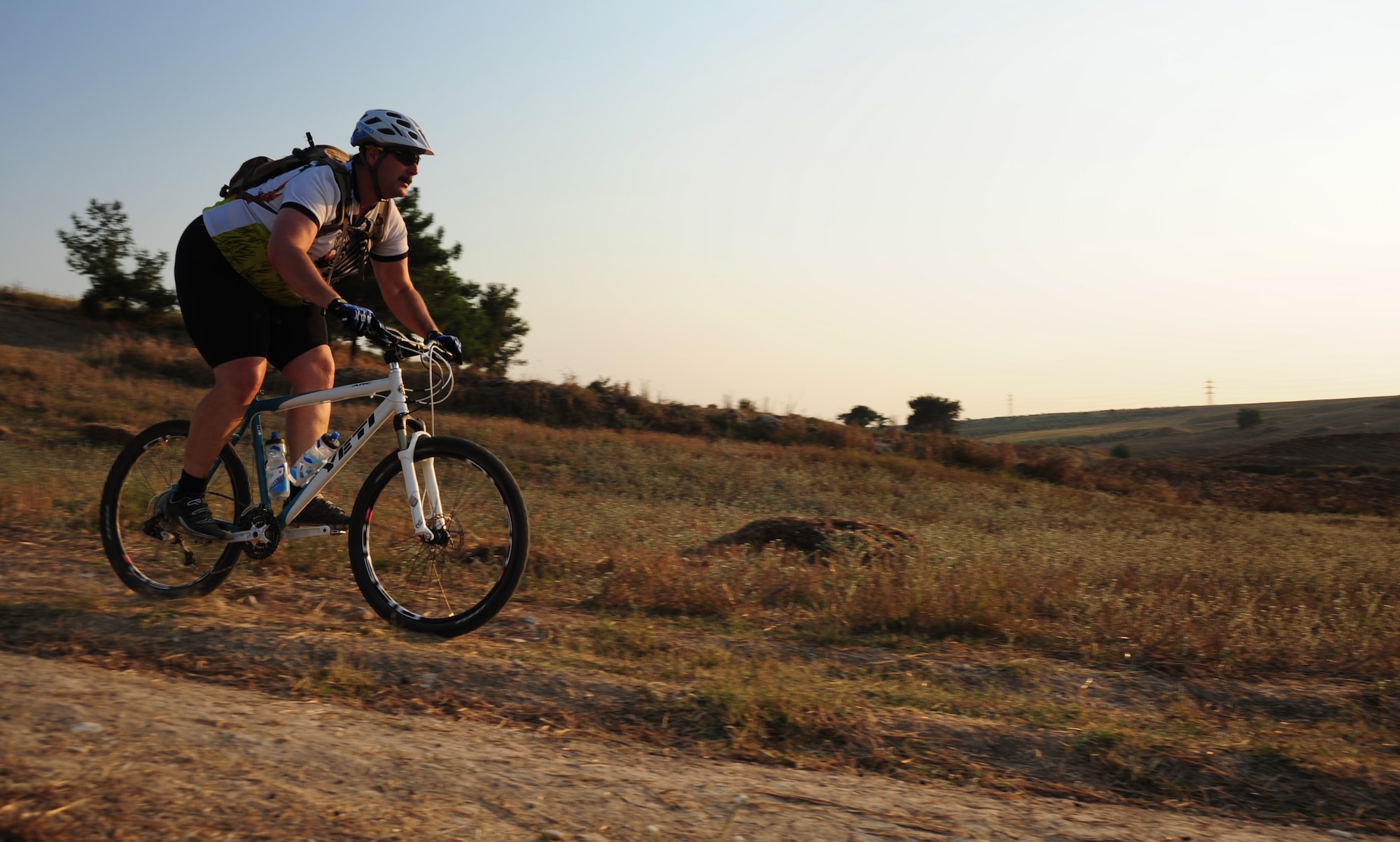 Staff Sgt. John Houseman, 728th Air Mobility Squadron cyber systems operations technician, right, and Master Sgt. John Anderson, 728th AMS NCO in charge of the maintenance operations center, ride on a dusty trail during a bike club ride Aug. 17, 2011, near Incirlik Village, Turkey. Started in Korea in 2006, the Beer Belly Bike Club expanded to Incirlik, Turkey when co-founder Hector Contreras and Philip Hammond, the club’s current organizer, began riding together in the summer of 2009. In addition to Incirlik, three other European and several stateside chapters have been started. (U.S. Air Force photo by Senior Airman Anthony Sanchelli/Released) 