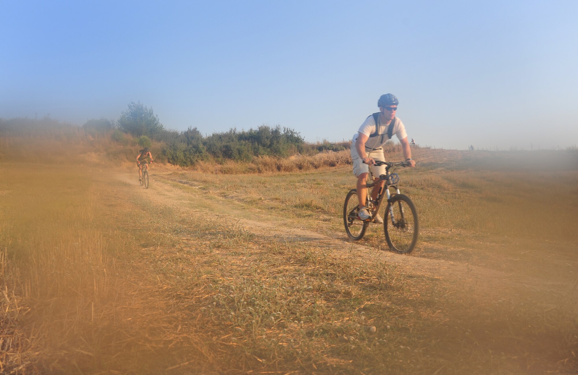 Staff Sgt. John Houseman, 728th Air Mobility Squadron cyber systems operations technician, right, and Master Sgt. John Anderson, 728th AMS NCO in charge of the maintenance operations center, ride on a dusty trail during a bike club ride Aug. 17, 2011, near Incirlik Village, Turkey. Started in Korea in 2006, the Beer Belly Bike Club expanded to Incirlik, Turkey when co-founder Hector Contreras and Philip Hammond, the club’s current organizer, began riding together in the summer of 2009. In addition to Incirlik, three other European and several stateside chapters have been started. (U.S. Air Force photo by Senior Airman Anthony Sanchelli/Released) 