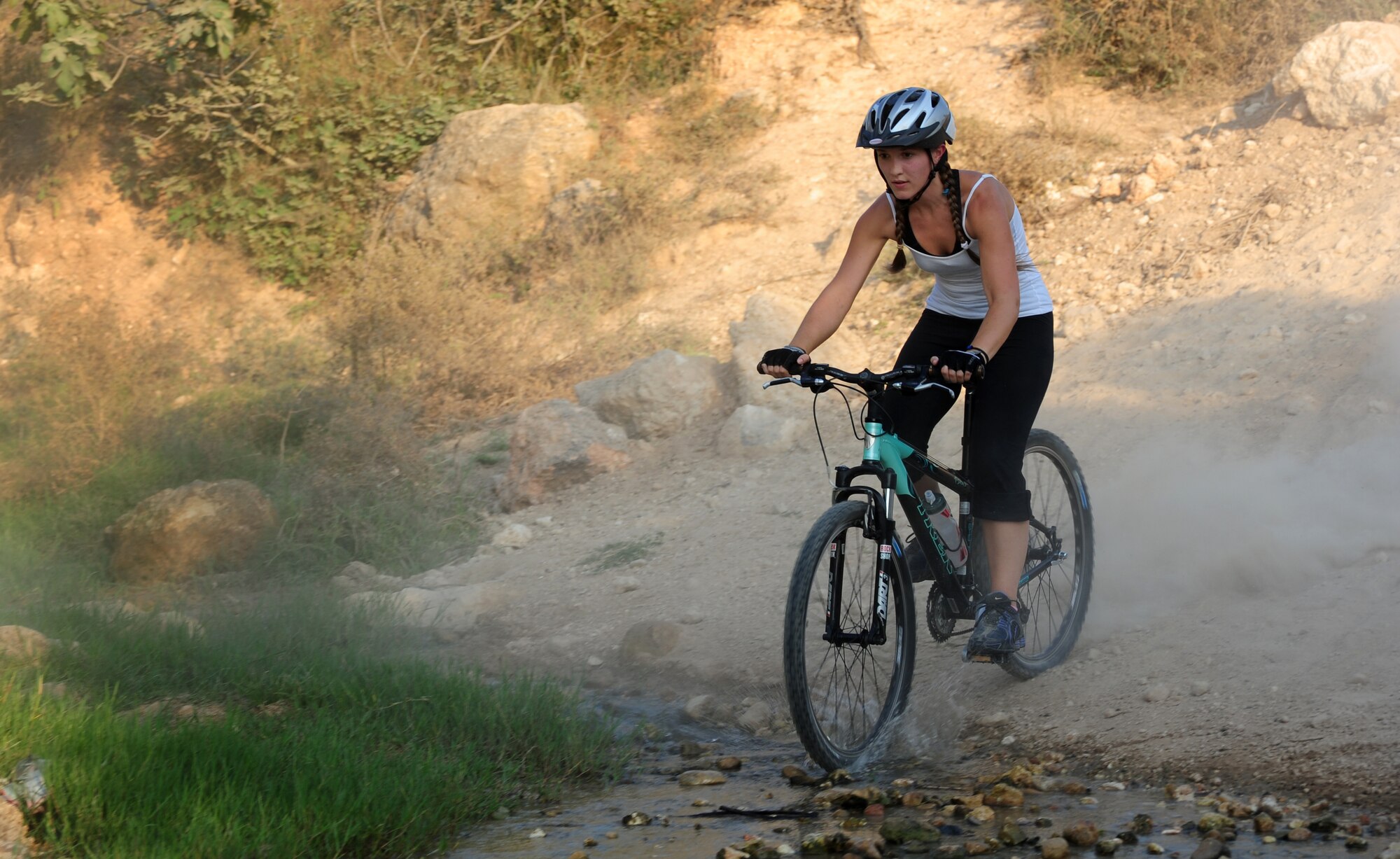 Briana Hughes, 39th Civil Engineer Squadron housing clerk, wheels down steep terrain during a bike club ride Aug. 17, 2011, near Incirlik Village, Turkey. Started in Korea in 2006, the Beer Belly Bike Club expanded to Incirlik, Turkey when co-founder Hector Contreras and Philip Hammond, the club’s current organizer, began riding together in the summer of 2009. In addition to Incirlik, three other European and several stateside chapters have been started. (U.S. Air Force photo by Senior Airman Anthony Sanchelli/Released) 