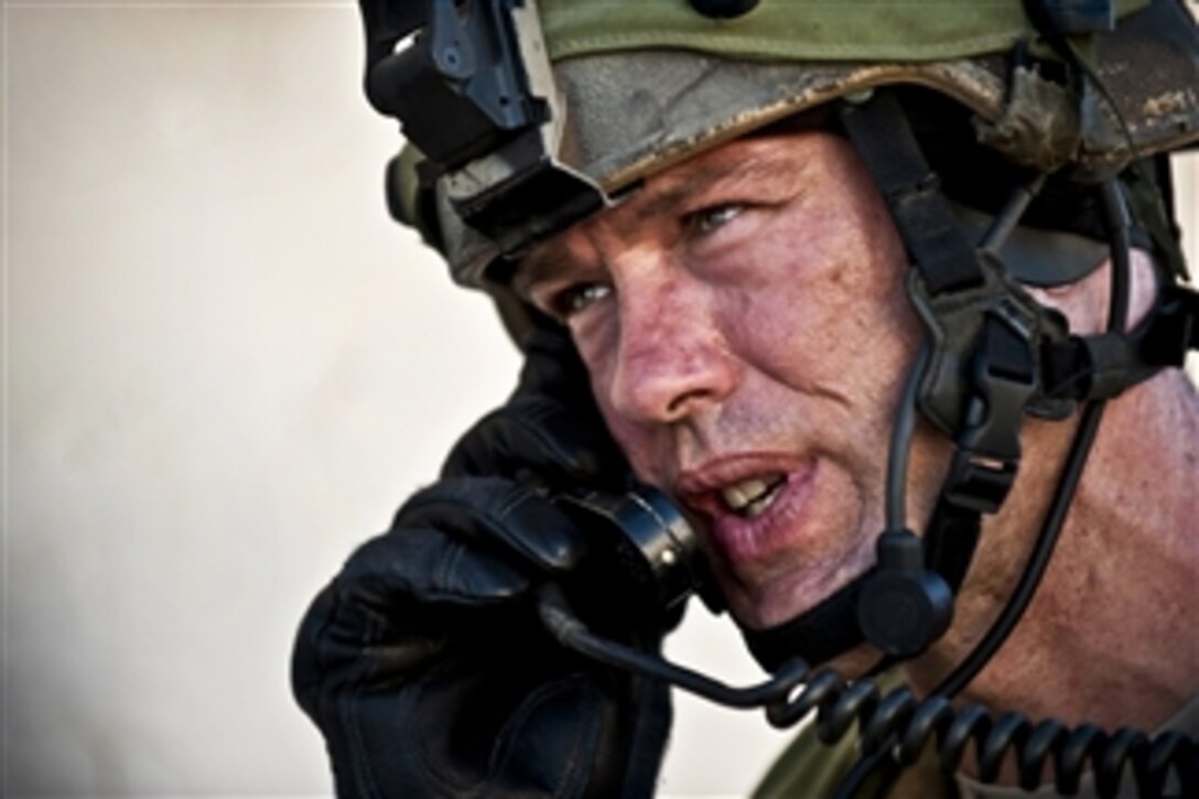 U.S. Air Force Tech. Sgt. Donald Urqhart calls for a simulated air strike on a high-value target during a Green Flag West 11-9 training exercise at the National Training Center at Fort Irwin, Calif., on Aug. 14, 2011.  Urqhart is the 5th Air Support Operations Squadron joint terminal attack controller.  