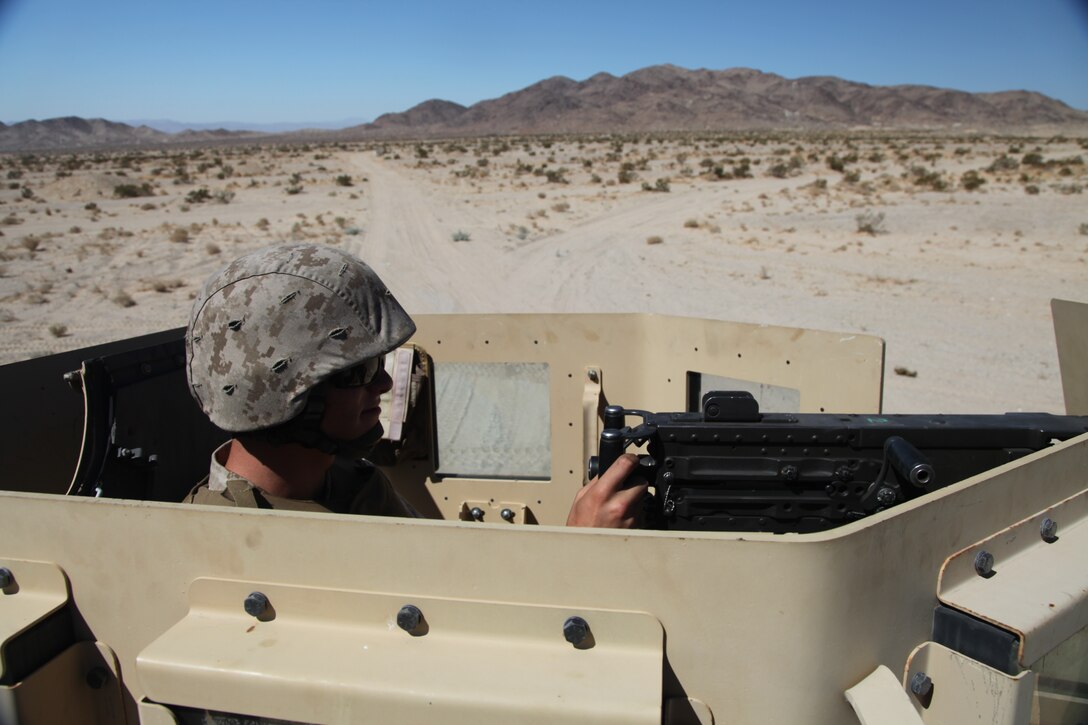 Pfc. William T. Barrios, a landing support specialist with Material Readiness Company, Combat Logistics Battalion 7, 1st Marine Logistics Group, mans the Mk-19 weapon system during a training convoy at Marine Corps Air Ground Combat Center Twentynine Palms, Calif., Aug. 19.