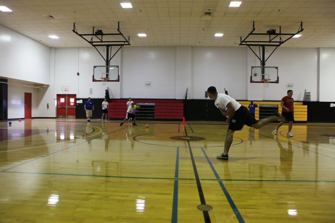 Lance Cpl. Justin Cabrera, (foreground) an amphibious assault vehicle crew chief with 2nd Assault Amphibian Battalion, 2nd Marine Division, lobs the dodgeball at the opposing player from the during the Dodgeball Championships at the Courthouse Bay Fitness Center,