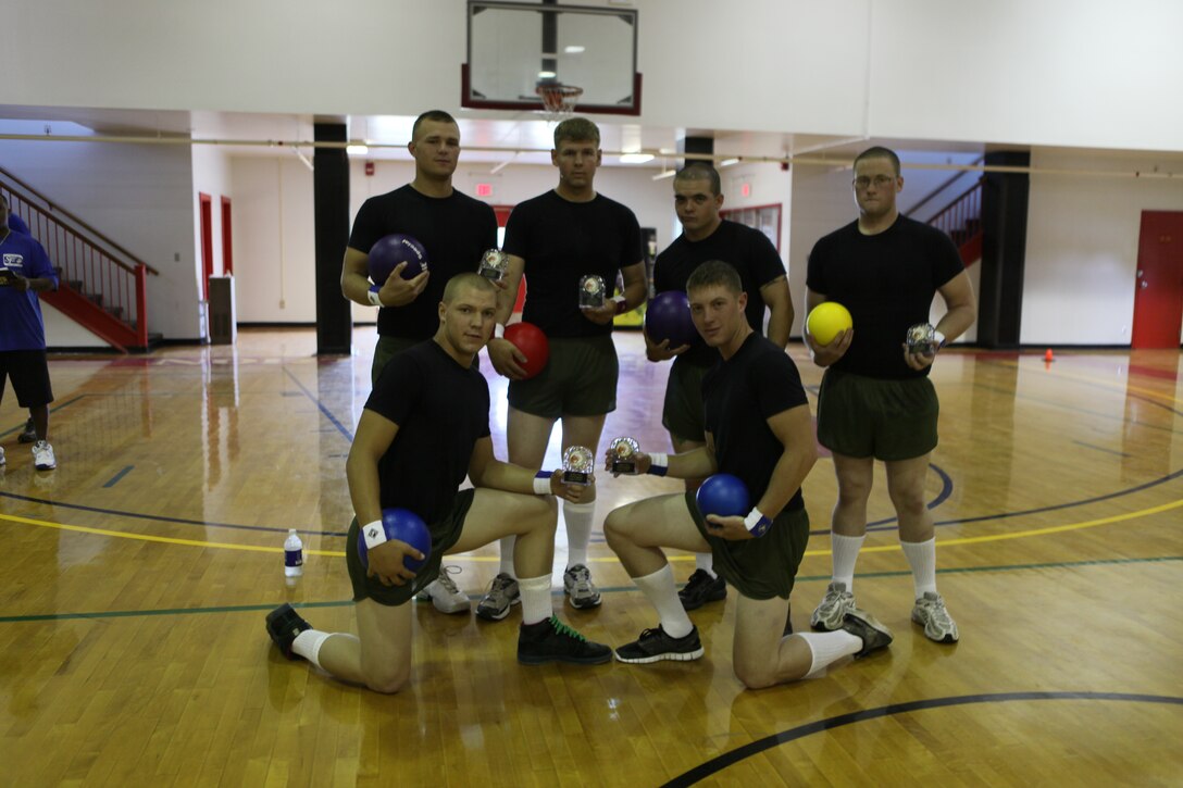 Marines from Combat Engineer Instruction Company, Marine Corps Engineer School, pose for a shot shortly after being crowned the champions of the dodgeball tournament hosted by Marine Corps Community Services at the Courthouse Bay Fitness Center, Marine Corps Base Camp Lejeune, Aug. 20.