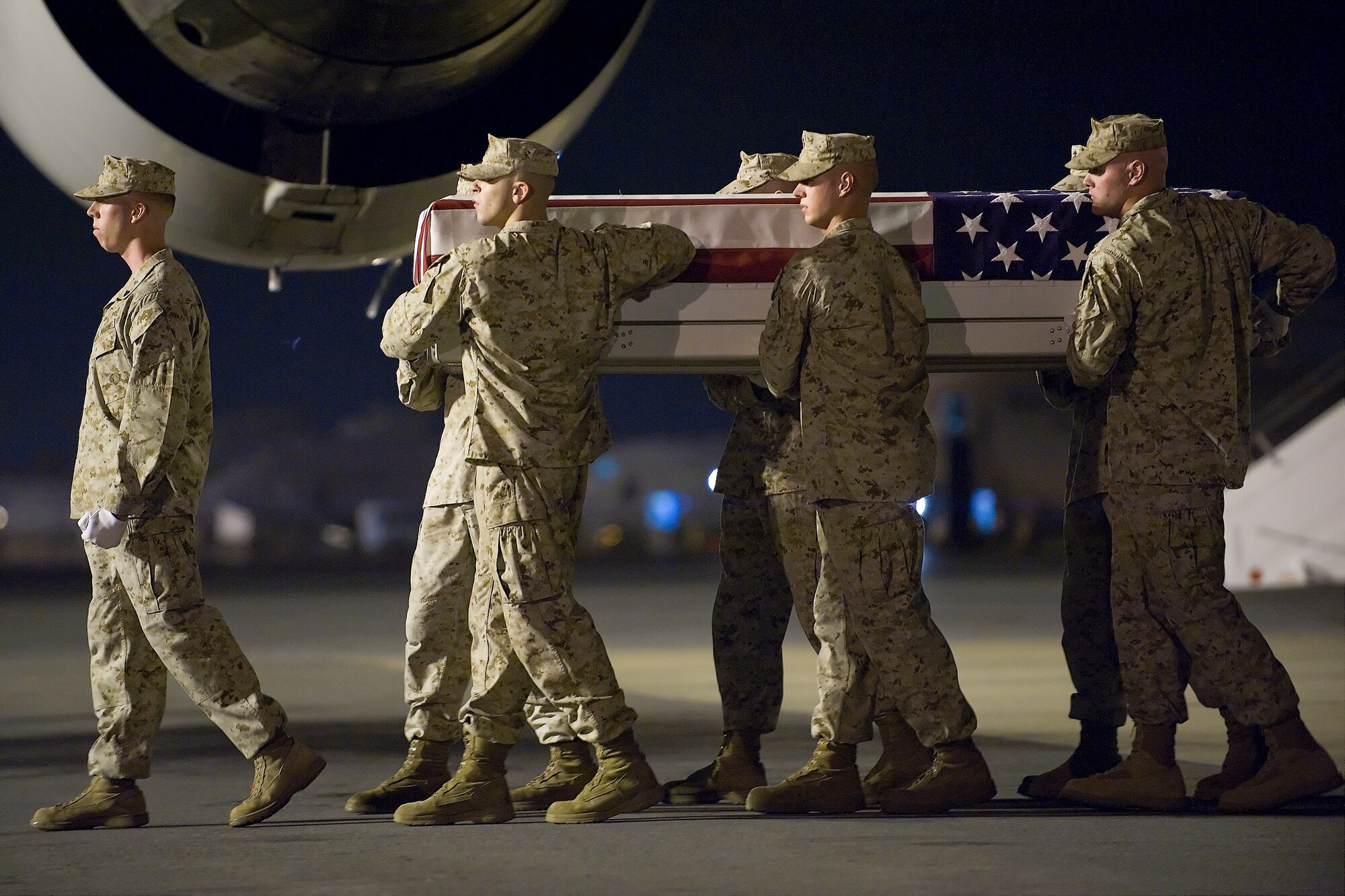 A U.S. Marine Corps carry team transfers the remains of Marine  Lance Cpl. Travis M. Nelson, of Pace, Fla., at Dover Air Force Base, Del., Aug. 20, 2011. Pace  was assigned to the 1st Battalion, 6th Marine Regiment, 2nd Marine Division, II Marine Expeditionary Force, Camp Lejuene, N.C. (U.S. Air Force photo/Steve Kotecki)