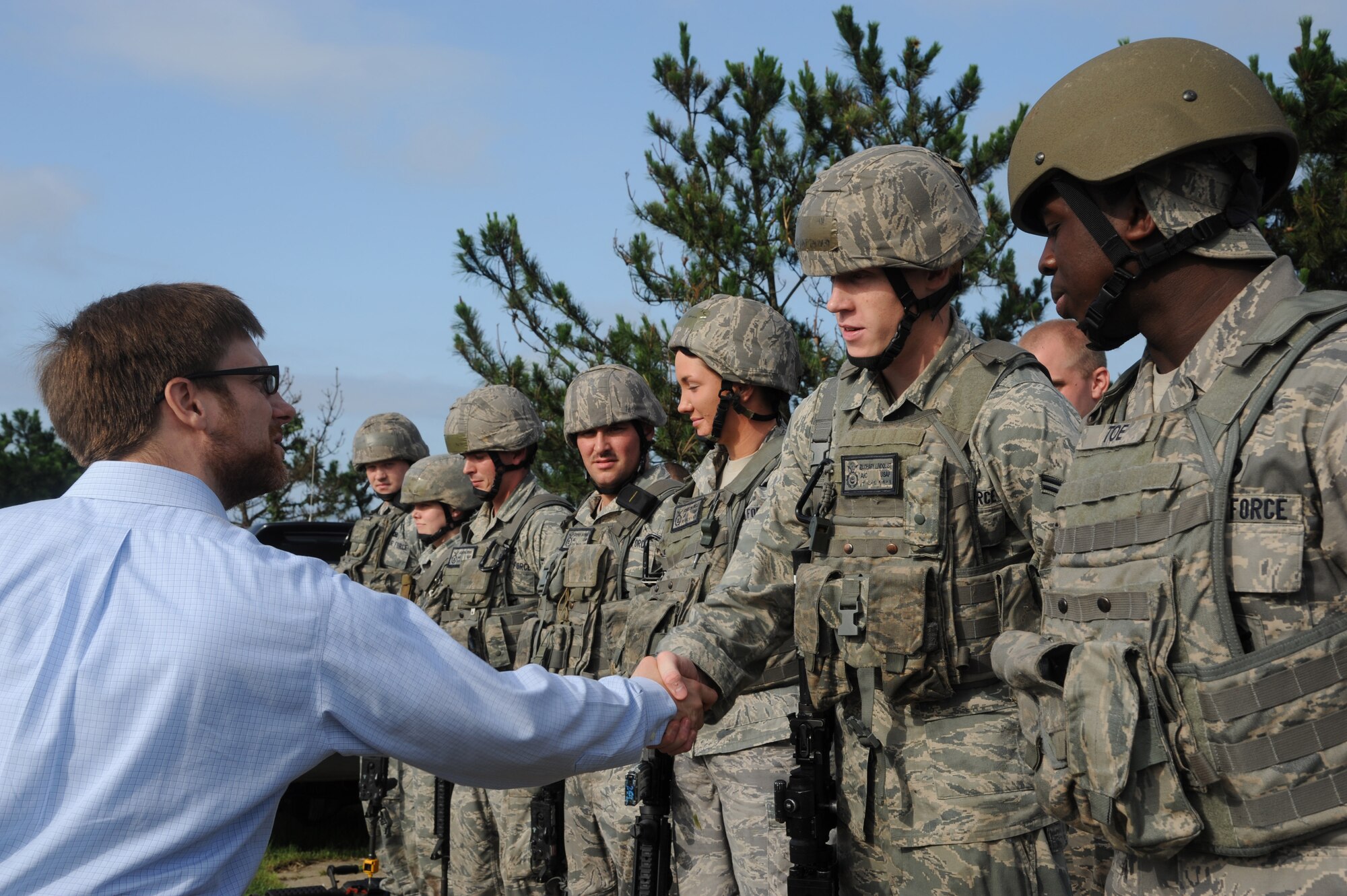 KUNSAN AIR BASE, Republic of Korea -- Dr. Jamie M. Morin, Assistant Secretary of the Air Force for Financial Management and Comptroller, shakes hands with members of the 8th Security Forces Squadron after their demonstration here Aug. 18. As part of a Pacific Air Forces tour, Morin visited Kunsan and spoke with many Wolf Pack members. (U.S. Air Force photo/Staff Sgt. Rasheen Douglas)