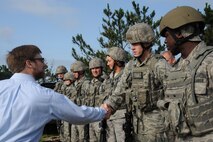 KUNSAN AIR BASE, Republic of Korea -- Dr. Jamie M. Morin, Assistant Secretary of the Air Force for Financial Management and Comptroller, shakes hands with members of the 8th Security Forces Squadron after their demonstration here Aug. 18. As part of a Pacific Air Forces tour, Morin visited Kunsan and spoke with many Wolf Pack members. (U.S. Air Force photo/Staff Sgt. Rasheen Douglas)