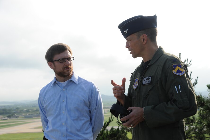 KUNSAN AIR BASE, Republic of Korea -- Col. Scott Pleus, 8th Fighter Wing commander, gives his Kunsan mission brief on Big Coyote hill to Dr. Jamie M. Morin, Assistant Secretary of the Air Force for Financial Management and Comptroller, here Aug. 18. As part of a Pacific Air Forces tour, Morin visited Kunsan and spoke with many Wolf Pack members. (U.S. Air Force photo/Staff Sgt. Rasheen Douglas)