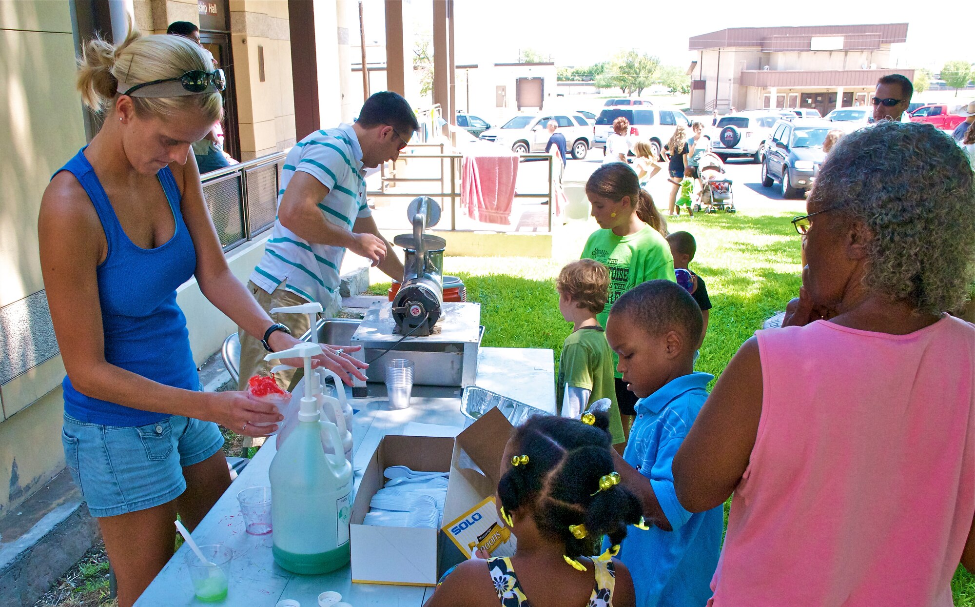 LAUGHLIN AIR FORCE BASE, Texas -- A volunteer serves up snow cones at the Fair by the Chapel here Aug. 21. The fair was open to the Laughlin community and offered food and games for all ages. (U.S. Air Force photo/Senior Airman Scott Saldukas)