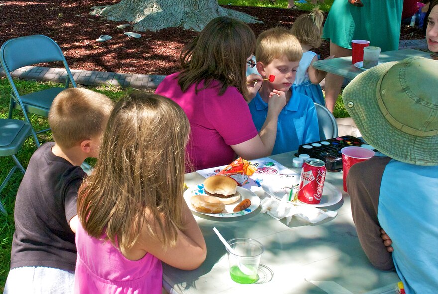 LAUGHLIN AIR FORCE BASE, Texas -- Kids look on as a boy gets his face painted at the Fair by the Chapel here Aug. 21. The fair was open to the Laughlin community and offered food and games for all ages. (U.S. Air Force photo/Senior Airman Scott Saldukas)