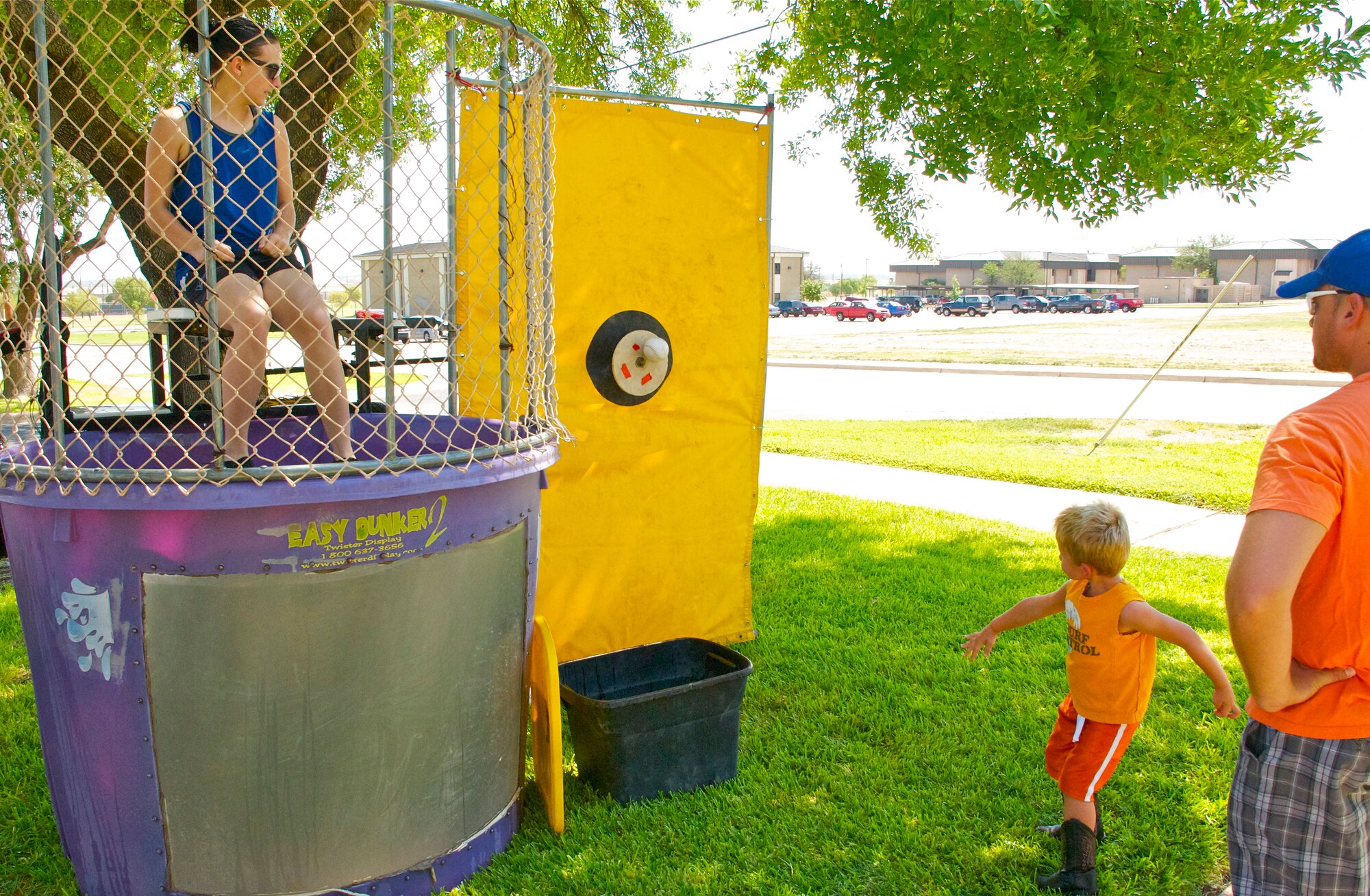 LAUGHLIN AIR FORCE BASE, Texas --  A boy hits the target and dunks a volunteer at the Fair by the Chapel here Aug. 21. The fair was open to the Laughlin community and offered food and games for all ages. (U.S. Air Force photo/Senior Airman Scott Saldukas)