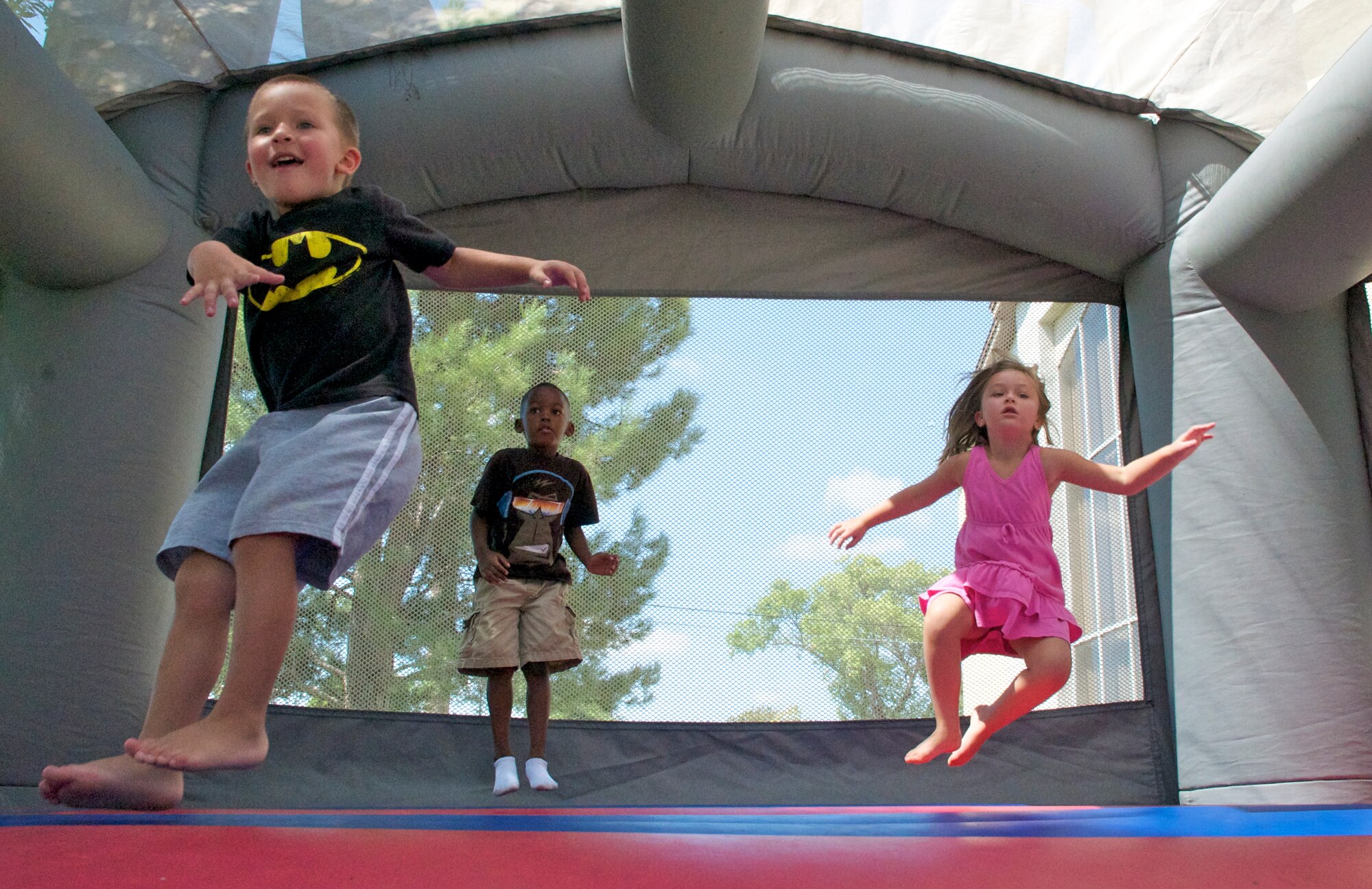 LAUGHLIN AIR FORCE BASE, Texas -- Kids jump in a bouncy castle at the Fair by the Chapel here Aug. 21. The fair was open to the Laughlin community and offered food and games for all ages. (U.S. Air Force photo/Senior Airman Scott Saldukas)