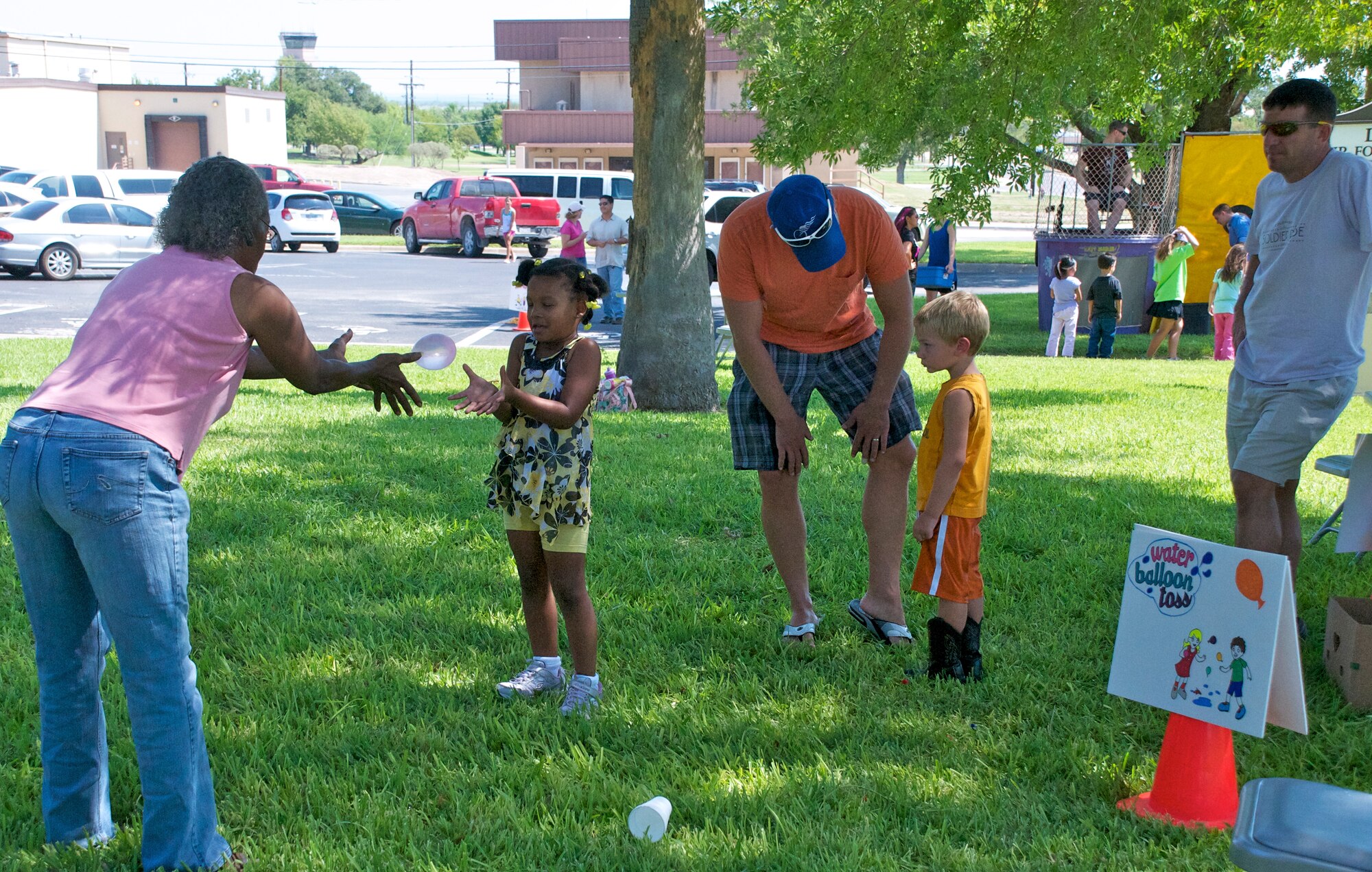 LAUGHLIN AIR FORCE BASE, Texas -- Families play catch with water balloons at the Fair by the Chapel here Aug. 21. The fair was open to the Laughlin community and offered food and games for all ages. (U.S. Air Force photo/Senior Airman Scott Saldukas)