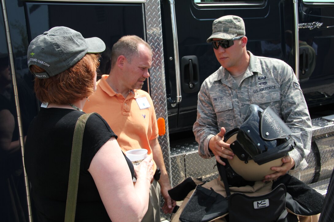 Senior Airman Blake Witte shows employers the protective helmet and suit that 932nd Civil Engineer Squadron (CES) EOD personnel use in the field.  Employers were also able to watch a controlled detonation at the EOD range.  Boss Day employers also toured the control tower and saw medical reservists conduct refresher training.  The 932nd Airlift Wing, Air Force Reserve, hosted the event which is held in association with the Employer Support of the Guard and Reserve. (U.S. Air Force photo/Tech. Sgt. Dan Oliver)
