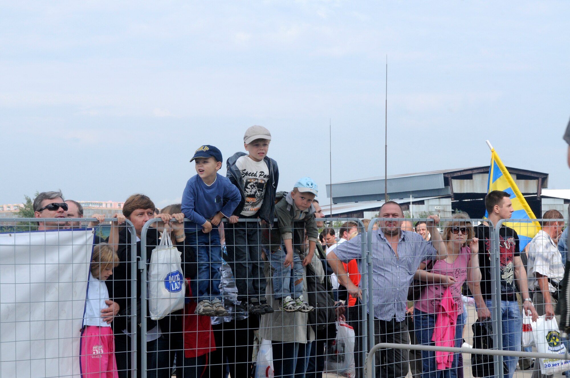 ZHUKOVSKY AIR FIELD, Russia – Children climb the fence while waiting for their turn to tour the C-5M Galaxy from Dover Air Force Base, Del., at the Moscow International Aviation and Space Salon, or MAKS 2011, here Aug. 20. MAKS is one of the premier events of its type in the world and Department of Defense participation demonstrates the United States commitment to international security, promotes international cooperation, and contributes to U.S. foreign policy objectives.  The U.S. Air Force has a KC-10 Extender, two F-16C Fighting Falcons, two A-10 Thunderbolt II, one F-15E Strike Eagle, one B-52 Stratotanker, C-130J Super Hercules, C-5M Galaxy, and a U.S. Navy P-3 Orion statics for the show. (U.S. Air Force photo/Master Sgt. Kelley J. Stewart)