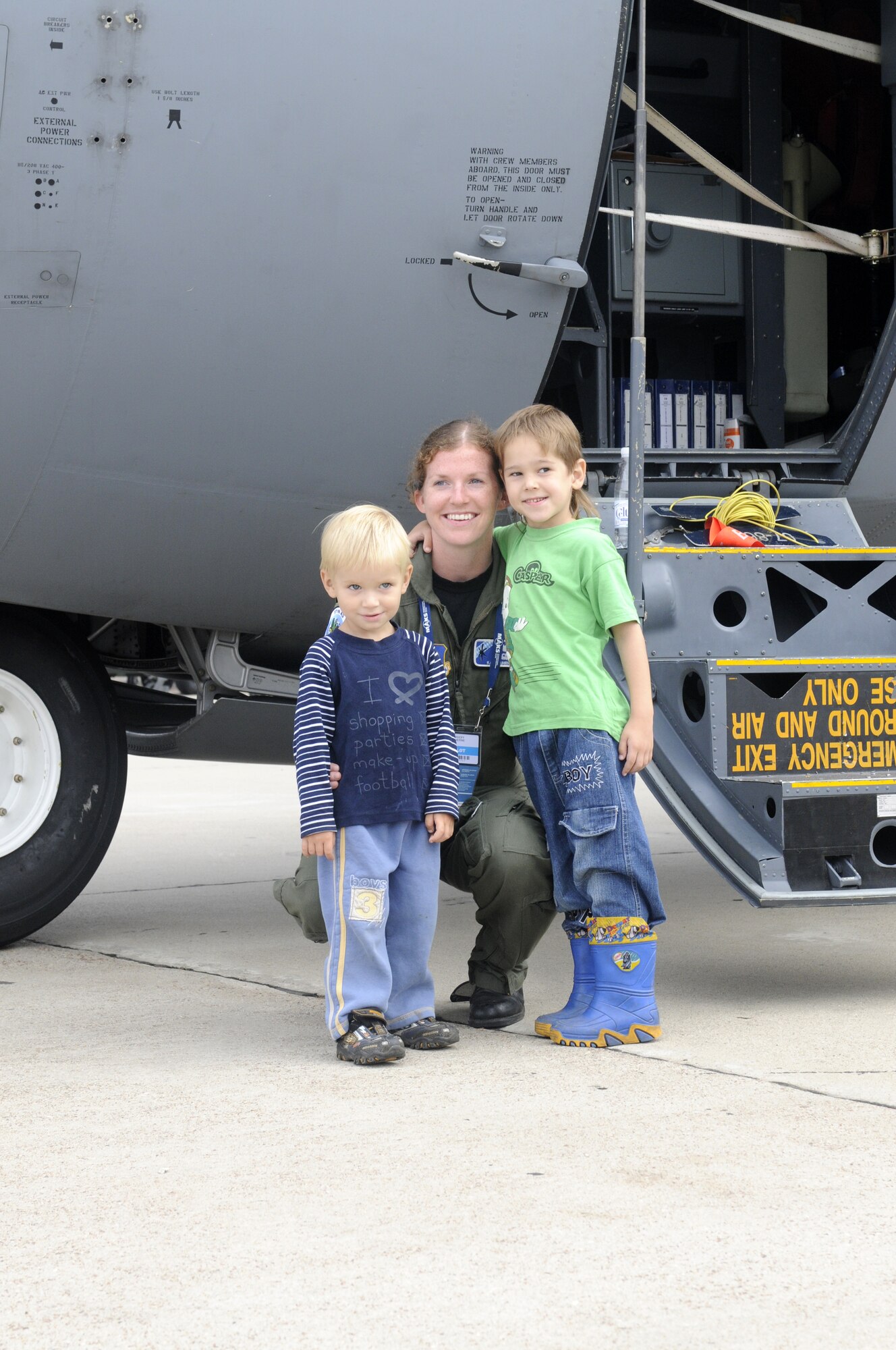 ZHUKOVSKY AIR FIELD, Russia – First Lt. Katie Suhrhoff, 37th Airlift Squadron co-pilot from Ramstein Air Base, Germany, poses for a photo with two Russian children in front of her C-130J Super Hercules at the Moscow International Aviation and Space Salon, or MAKS 2011, here Aug. 20. MAKS is one of the premier events of its type in the world and Department of Defense participation demonstrates the United States commitment to international security, promotes international cooperation, and contributes to U.S. foreign policy objectives.  The U.S. Air Force has a KC-10 Extender, two F-16C Fighting Falcons, two A-10 Thunderbolt II, one F-15E Strike Eagle, one B-52 Stratotanker, C-130J Super Hercules, C-5M Galaxy, and a U.S. Navy P-3 Orion statics for the show. (U.S. Air Force photo/Master Sgt. Kelley J. Stewart)