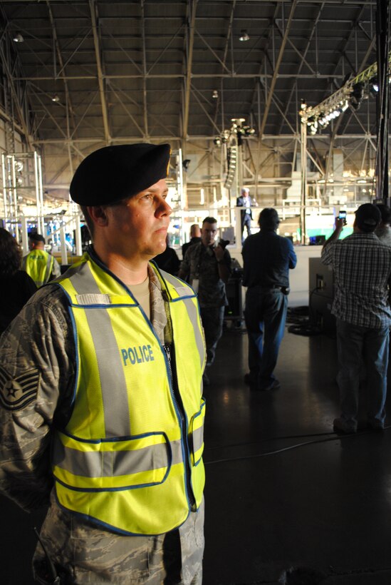 Tech. Sgt. Michael Chapman, 433rd Security Forces Squadron member, guards the stage while comedian Jay Leno performs an hour-long comedy show for more than 2,000 people who attended the, "Tour for the Troops," event hosted by the 433rd Airlift Wing, Aug. 6, 2011, at Lackland Air Force Base, Texas. "Tour for the Troops," is part  the Air Force Reserve Command's recruiting program, "Get 1 Now."  Sergeant Chapman was one of several 433 SFS members who provided security throughout the event.(U.S. Air Force photo/Senior Airman Luis Loza Gutierrez)