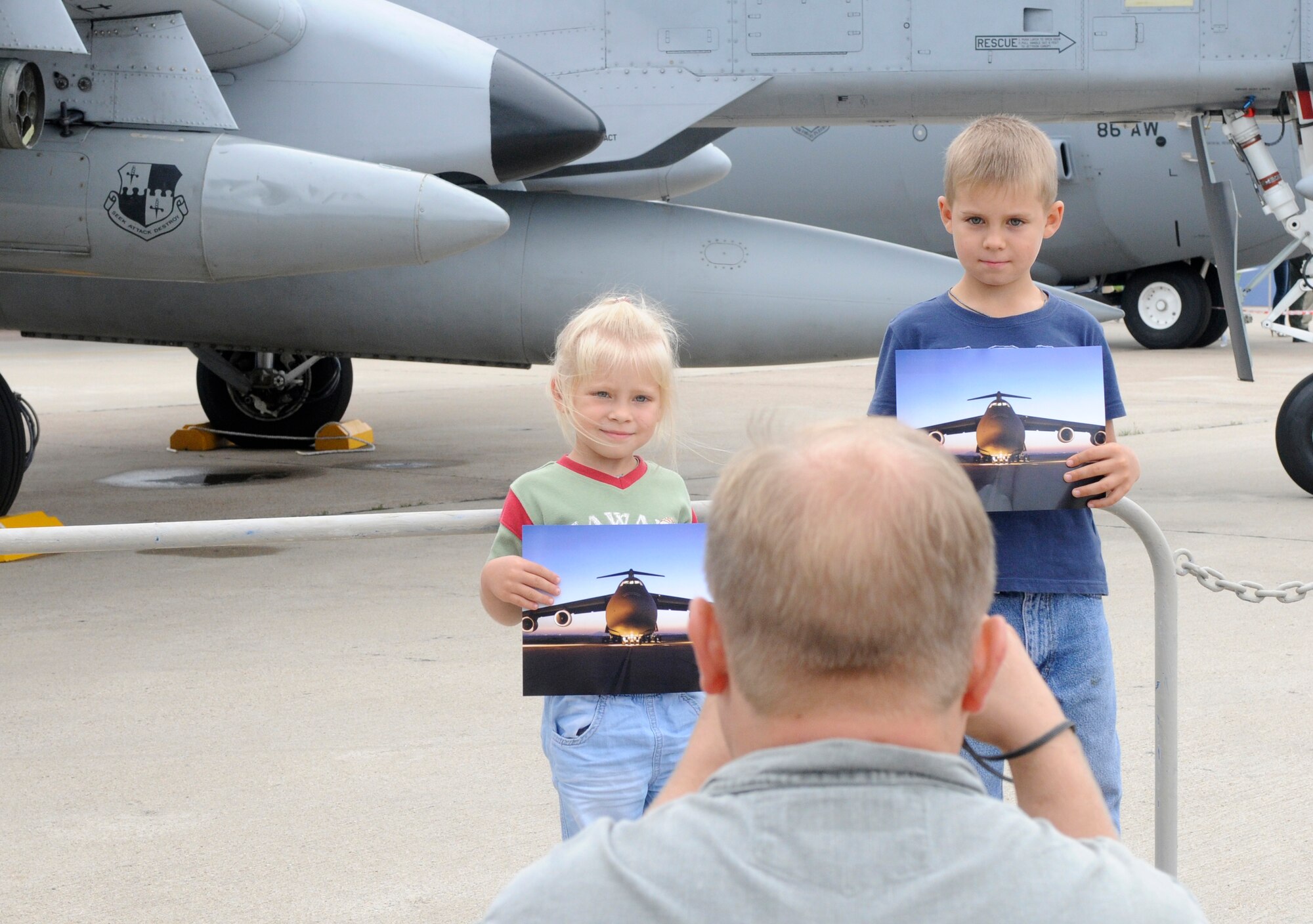 ZHUKOVSKY AIR FIELD, Russia – A father takes a photo of his children after their tour of a C-5M Galaxy from Dover Air Force Base, Del., at the Moscow International Aviation and Space Salon, or MASK 2100, here Aug. 20. MAKS is one of the premier events of its type in the world and Department of Defense participation demonstrates the United States commitment to international security, promotes international cooperation, and contributes to U.S. foreign policy objectives.  The U.S. Air Force has a KC-10 Extender, two F-16C Fighting Falcons, two A-10 Thunderbolt II, one F-15E Strike Eagle, one B-52 Stratotanker, C-130J Super Hercules, C-5M Galaxy, and a U.S. Navy P-3 Orion statics for the show. (U.S. Air Force photo/Master Sgt. Kelley J. Stewart)