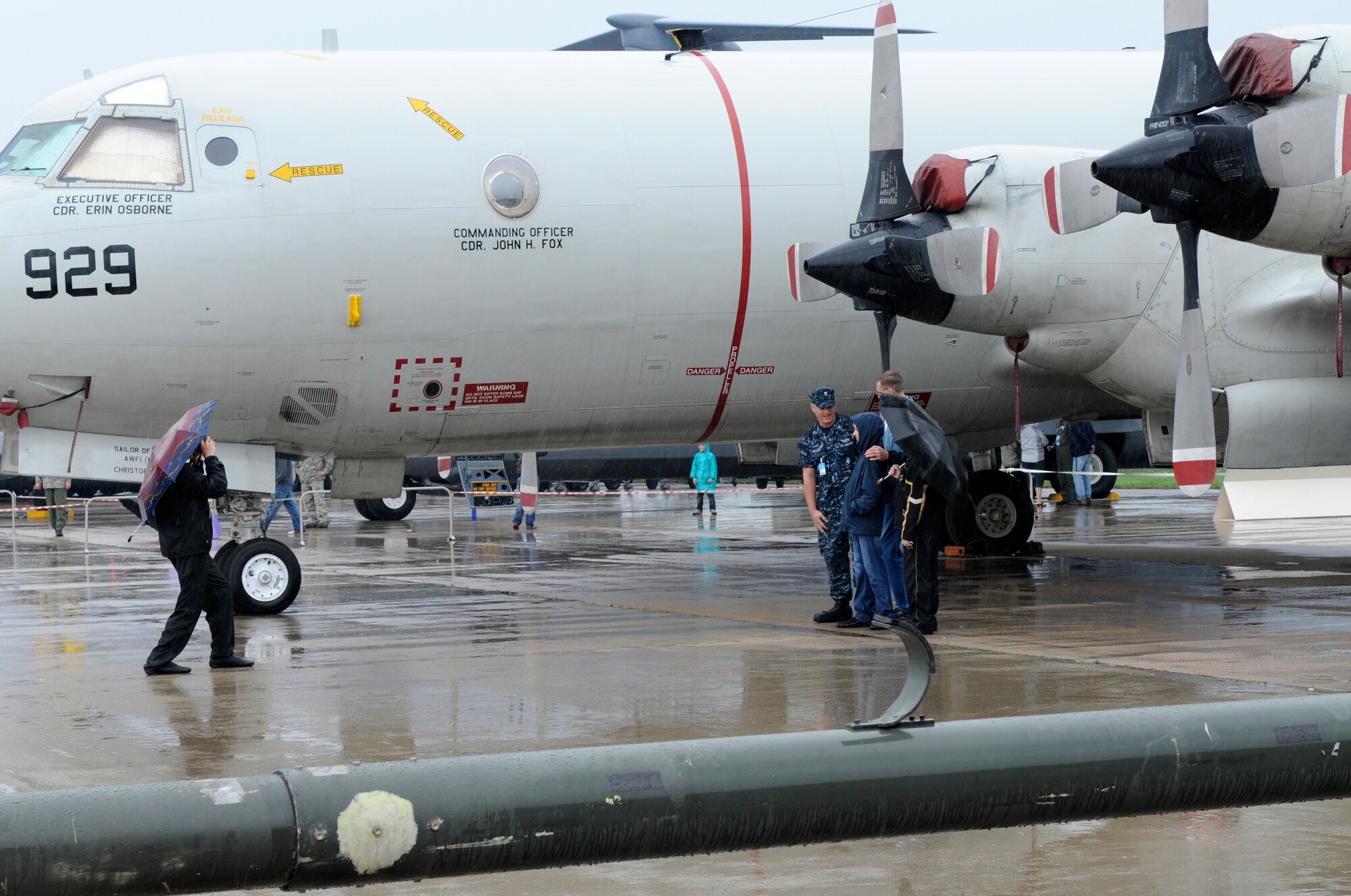 ZHUKOVSKY AIR FIELD, Russia – U.S. Navy Petty Officer 2nd Class Scott Walker, maintenance, from Maritime Patrol Squadron 45 from Naval Air Station Jacksonville, Fla., poses in front of his P-3 Orion for photos with Russian visitors to the Moscow International Aviation and Space Salon, or MAKS 2011, here Aug. 20. MAKS is one of the premier events of its type in the world and Department of Defense participation demonstrates the United States commitment to international security, promotes international cooperation, and contributes to U.S. foreign policy objectives.  The U.S. Air Force has a KC-10 Extender, two F-16C Fighting Falcons, two A-10 Thunderbolt II, one F-15E Strike Eagle, one B-52 Stratotanker, C-130J Super Hercules, C-5M Galaxy, and a U.S. Navy P-3 Orion statics for the show. (U.S. Air Force photo/Master Sgt. Kelley J. Stewart)