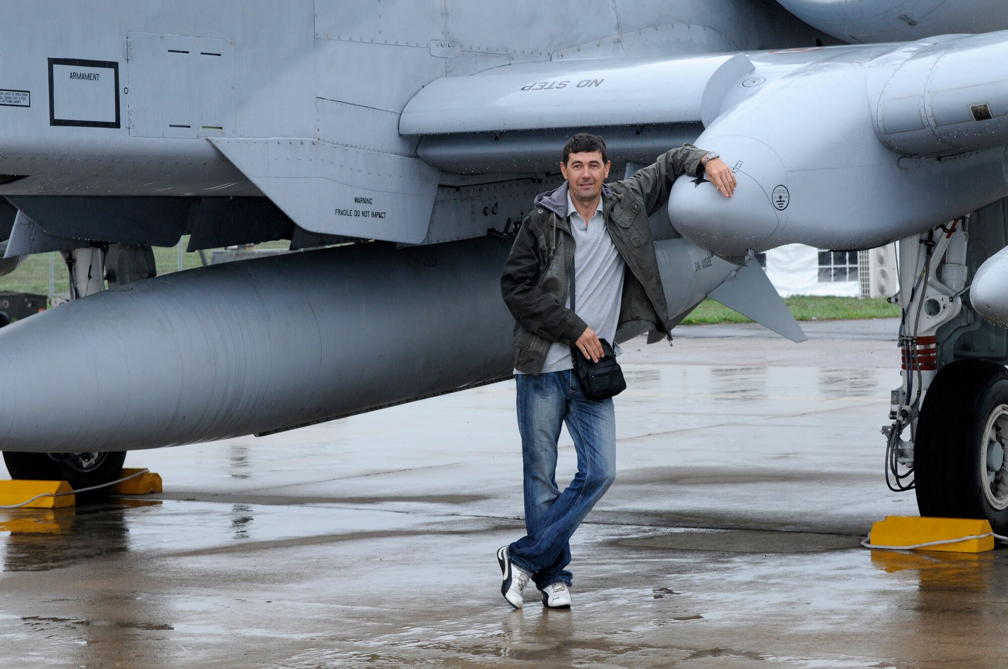 ZHUKOVSKY AIR FIELD, Russia – A Russian visitor has his photo taken in front of an A-10 Thunderbolt II from Spangdahlem Air Base, Germany, at the Moscow International Aviation and Space Salon, or MAKS 2011, here Aug. 20. MAKS is one of the premier events of its type in the world and Department of Defense participation demonstrates the United States commitment to international security, promotes international cooperation, and contributes to U.S. foreign policy objectives.  The U.S. Air Force has a KC-10 Extender, two F-16C Fighting Falcons, two A-10 Thunderbolt II, one F-15E Strike Eagle, one B-52 Stratotanker, C-130J Super Hercules, C-5M Galaxy, and a U.S. Navy P-3 Orion statics for the show. (U.S. Air Force photo/Master Sgt. Kelley J. Stewart)