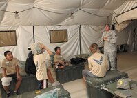 Tech. Sgt. Barry Nix, a traditional Air Force reservist at the Basic Expeditionary Airman Skills Training compound, briefs children participating in Operation JET. (U.S. Air Force photo/Robbin Cresswell)