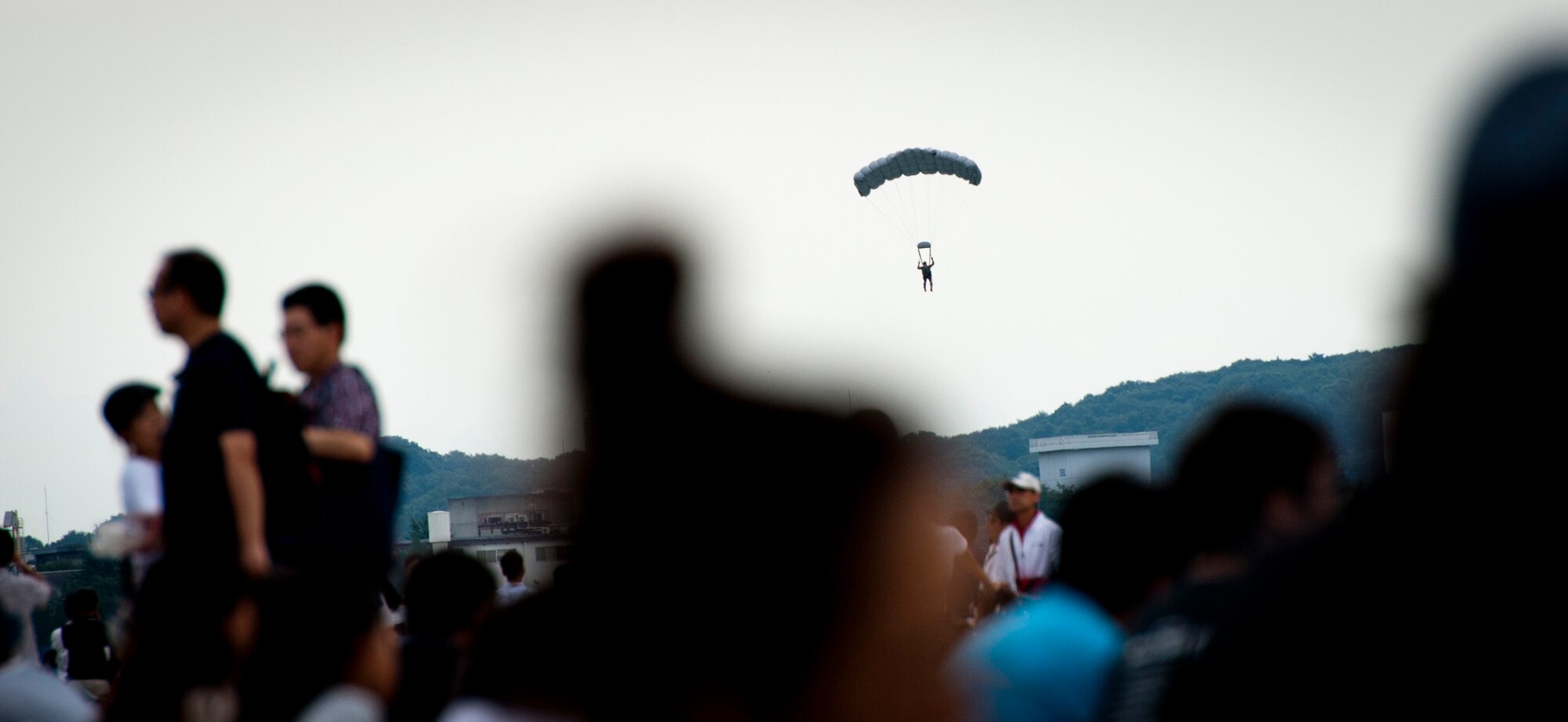 YOKOTA AIR BASE, Japan -- A pararescuemen from the 31st Rescue Squadron, Kadena Air Base, Japan, descends to the ground after jumping out of a C-130 Hercules during a demonstration at the Japanese-American Friendship Festival at Yokota Air Base, Japan, Aug. 20, 2011. (U.S. Air Force photo/Staff Sgt. Samuel Morse)
