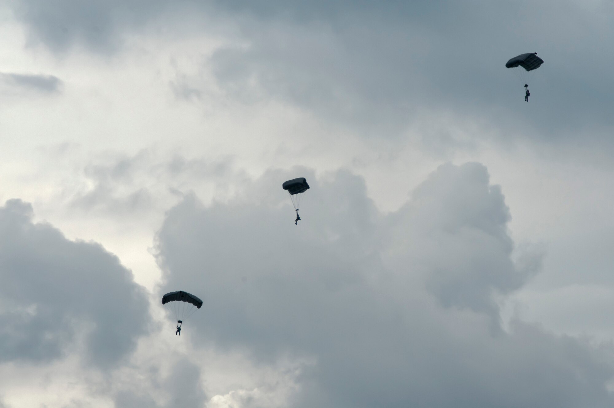 YOKOTA AIR BASE, Japan -- Pararescuemen from the 31st Rescue Squadron, Kadena Air Base, Japan, descend to the ground after jumping out of a C-130 Hercules during a demonstration at the Japanese-American Friendship Festival at Yokota Air Base, Japan, Aug. 20, 2011. (U.S. Air Force photo/Staff Sgt. Samuel Morse)