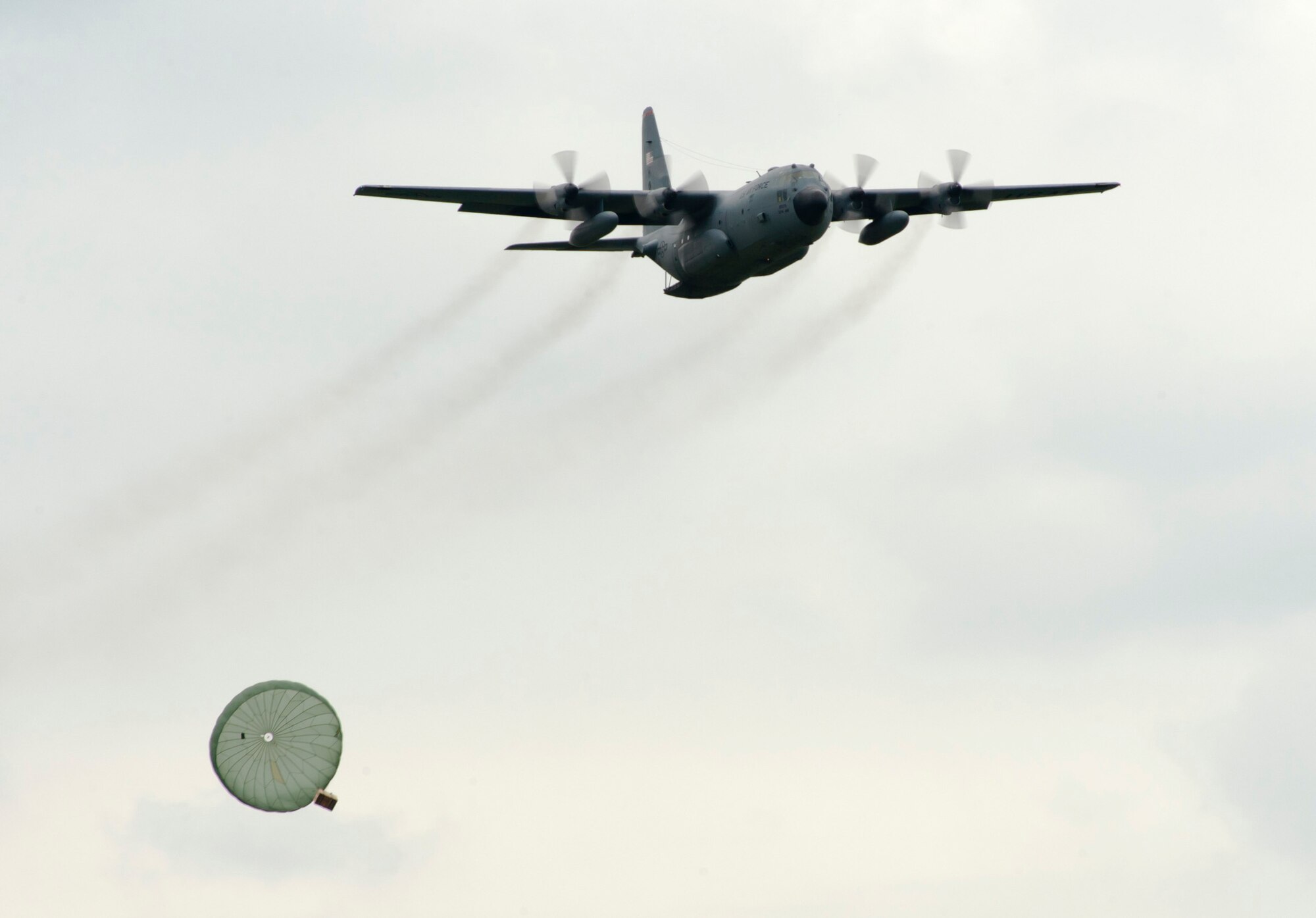 YOKOTA AIR BASE, Japan -- A C-130 Hercules drops a practice load over the drop zone at Yokota Air Base, Japan, Aug. 20, 2011, during the Japanese-American Friendship Festival. (U.S. Air Force photo/Staff Sgt. Samuel Morse)
