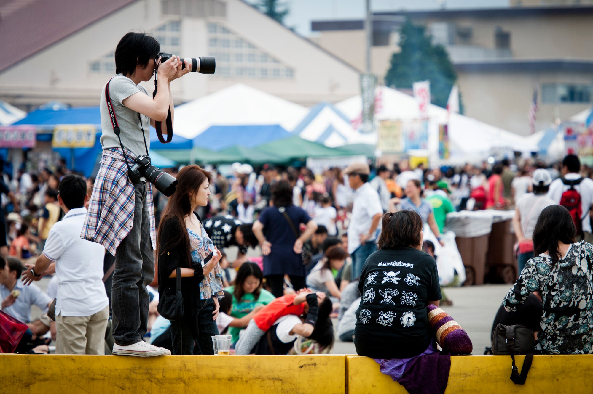 YOKOTA AIR BASE, Japan -- A Japanese photographer takes photographs of an aerial demonstration Aug. 20, 2011, during the Japanese-American Friendship Festival held at Yokota Air Base, Japan. (U.S. Air Force photo/Staff Sgt. Samuel Morse)