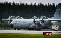 YOKOTA AIR BASE, Japan -- A C-130 Hercules performs a demonstration of a combat offload Aug. 21, 2011, during the Japanese-American Friendship Festival at Yokota Air Base, Japan. In a combat offload, the pilot of the C-130 boosts the throttle to full while the brakes are applied, and then releases the brakes using inertia to push cargo out the open back door of the aircraft. (U.S. Air Force photo/Staff Sgt. Samuel Morse)
