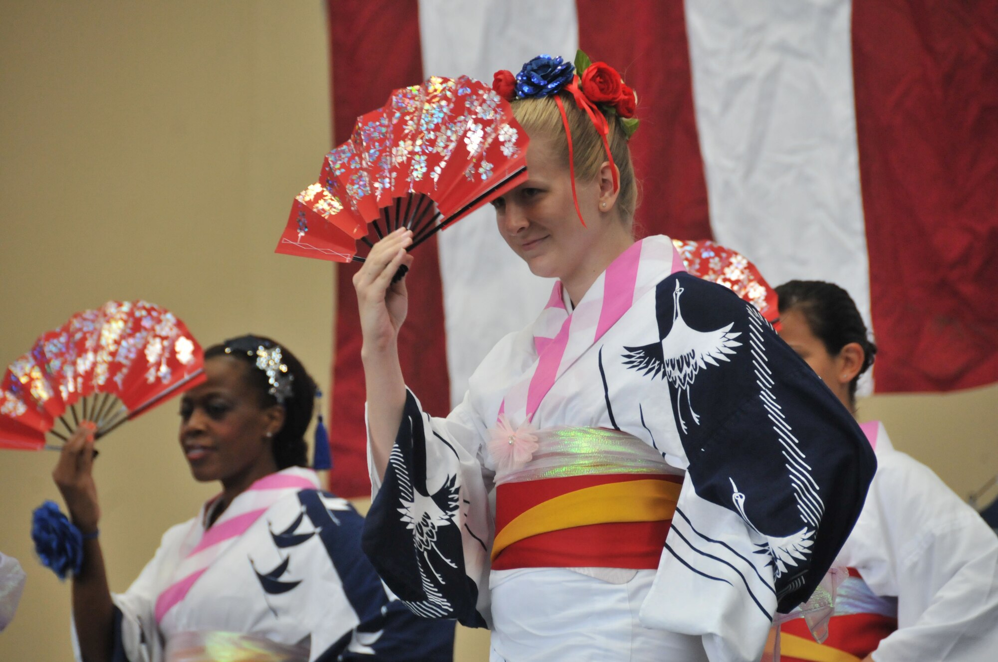 YOKOTA AIR BASE, Japan -- (From left to right) Suzie Jeffrey, Sarah Maley and Patricia Brandon, perform the Japanese dance Ayame at Yokota Air Base, Japan, Aug. 21, 2011, during the Japanese- American Friendship Festival. These women are part of the Yokota Tanabata Dancers, a group established in 1973 to promote goodwill and friendship to the Japanese by learning traditional dances and joining in Japanese festivals. (U.S. Air Force photo/Airman 1st Class Desiree Economides)