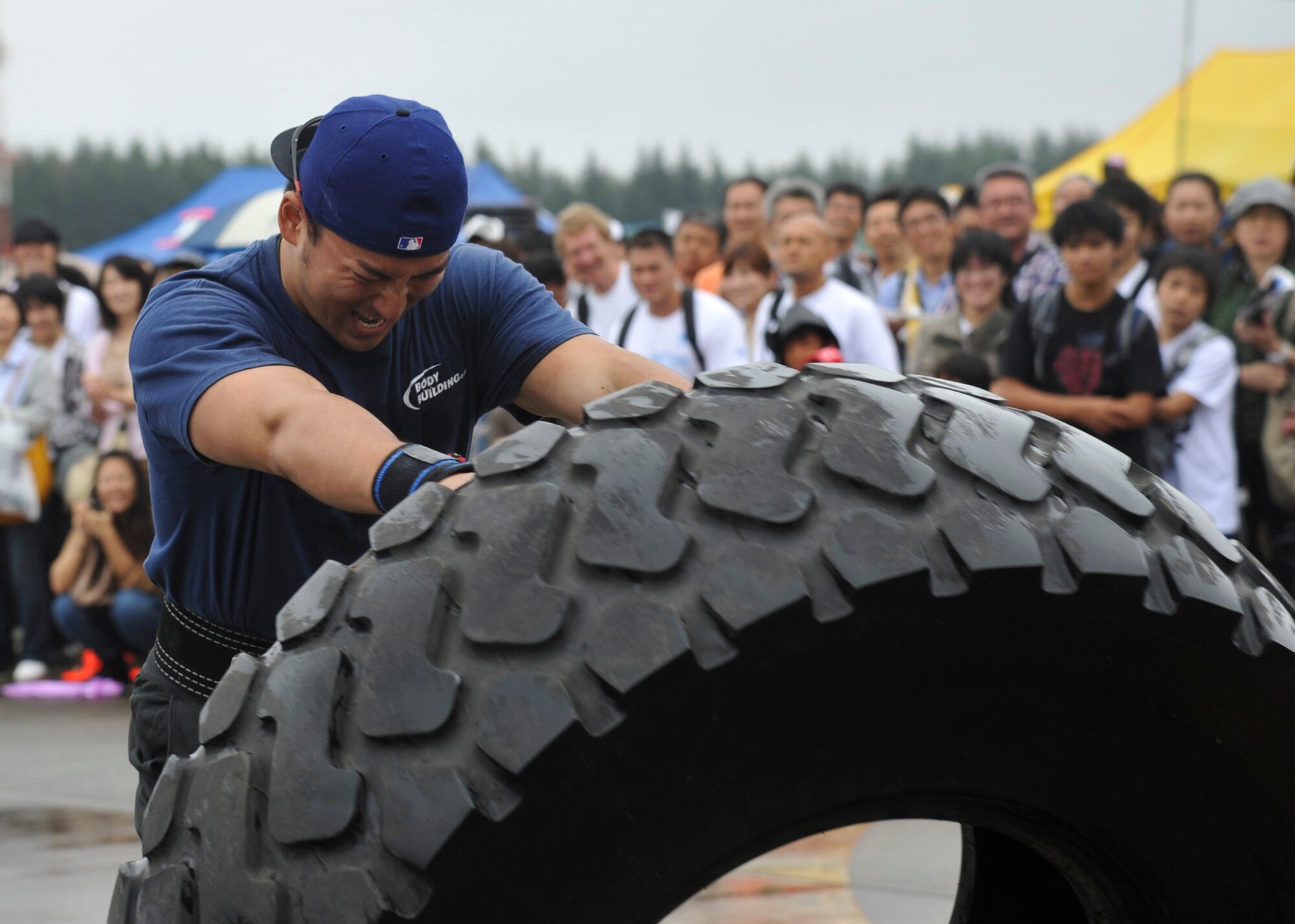 YOKOTA AIR BASE, Japan -- Hideyuki Ohtake flips a tire toward the finish line during the 2011 Strongman Competition at Yokota Air Base, Japan, Aug. 21, 2011. The "tire flip" was one of six events challenging participants' strength, agility and speed.  (U.S. Air Force photo/Senior Airman Andrea Salazar)