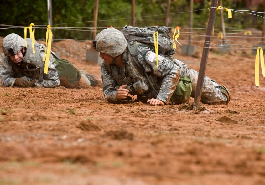Members of the 2nd Security Forces Squadron Global Strike Challenge team from Barksdale Air Force Base, La., crawl through the mud to complete one of many obstacles they faced during the challenge. Security Forces Airmen from Air Force Global Strike Command, Air Combat Command, and Air Reserve components came together at Barksdale to compete. (U.S. Air Force photo by Senior Airman Chad Warren)(RELEASED)
