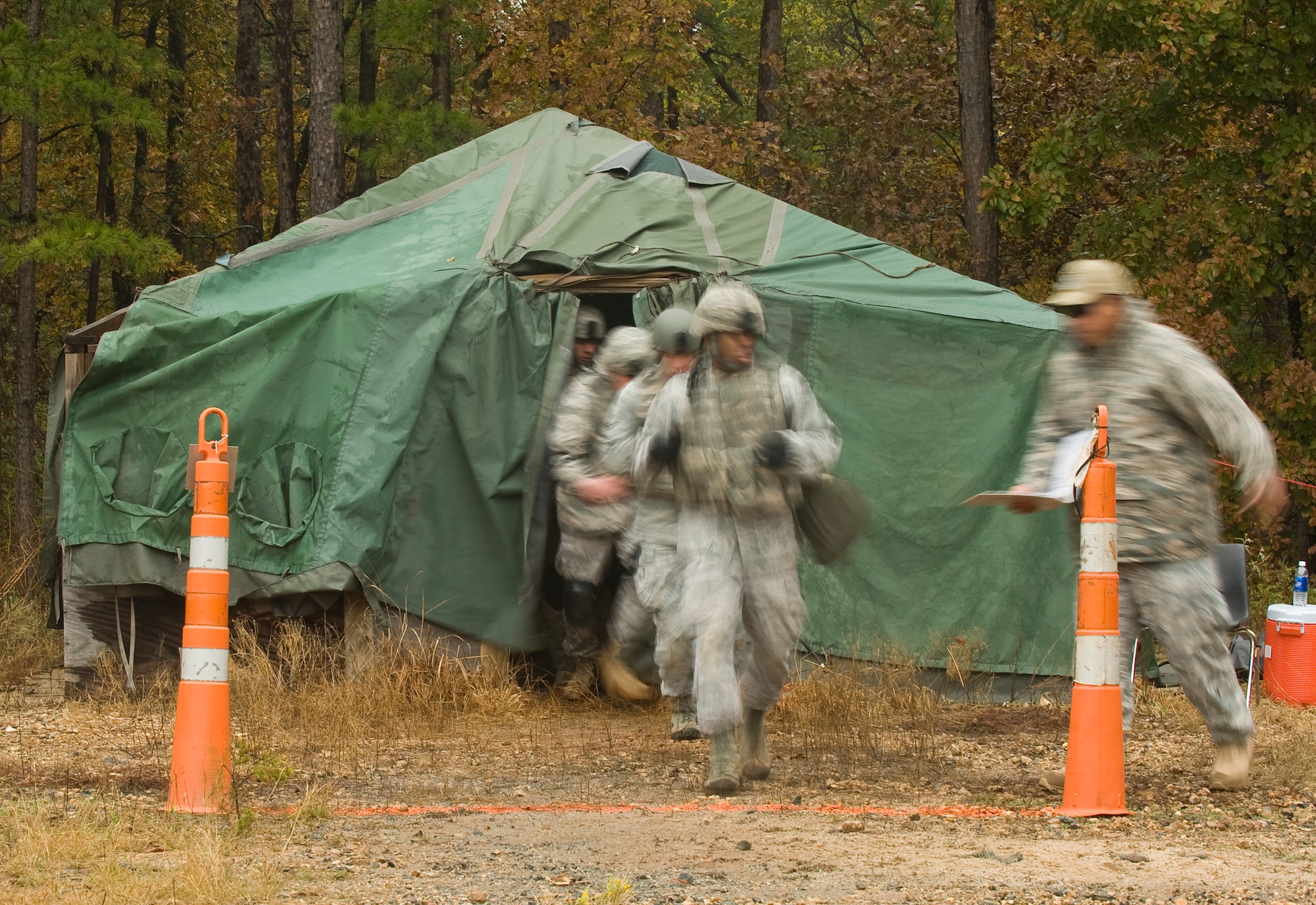 Security Forces Airmen competing in the Global Strike Challenge exit a tent during the mental and physical challenge scenario portion of the competition. The MAP challenge is a strenuous course consisting of multiple scenarios and obstacles that each security forces team must complete. Security Forces Airmen from Air Force Global Strike Command, Air Combat Command, and Air Reserve components came together at Barksdale Air Force Base, La., to compete. (U.S. Air Force photo by Senior Airman Chad Warren)(RELEASED)