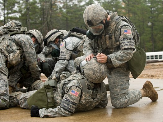Airman 1st Class Sean Phelan, a member of the 2nd Security Forces Squadron Global Strike Challenge team from Barksdale Air Force Base, La., tends to a simulated casualty during a scenario of the mental and physical challenge portion of the competition. The MAP challenge is a strenuous course consisting of multiple scenarios and obstacles that each security forces team must complete. Security Forces Airmen from Air Force Global Strike Command, Air Combat Command, and Air Reserve components came together at Barksdale Air Force Base, La., to compete. (U.S. Air Force photo by Senior Airman Chad Warren)(RELEASED)