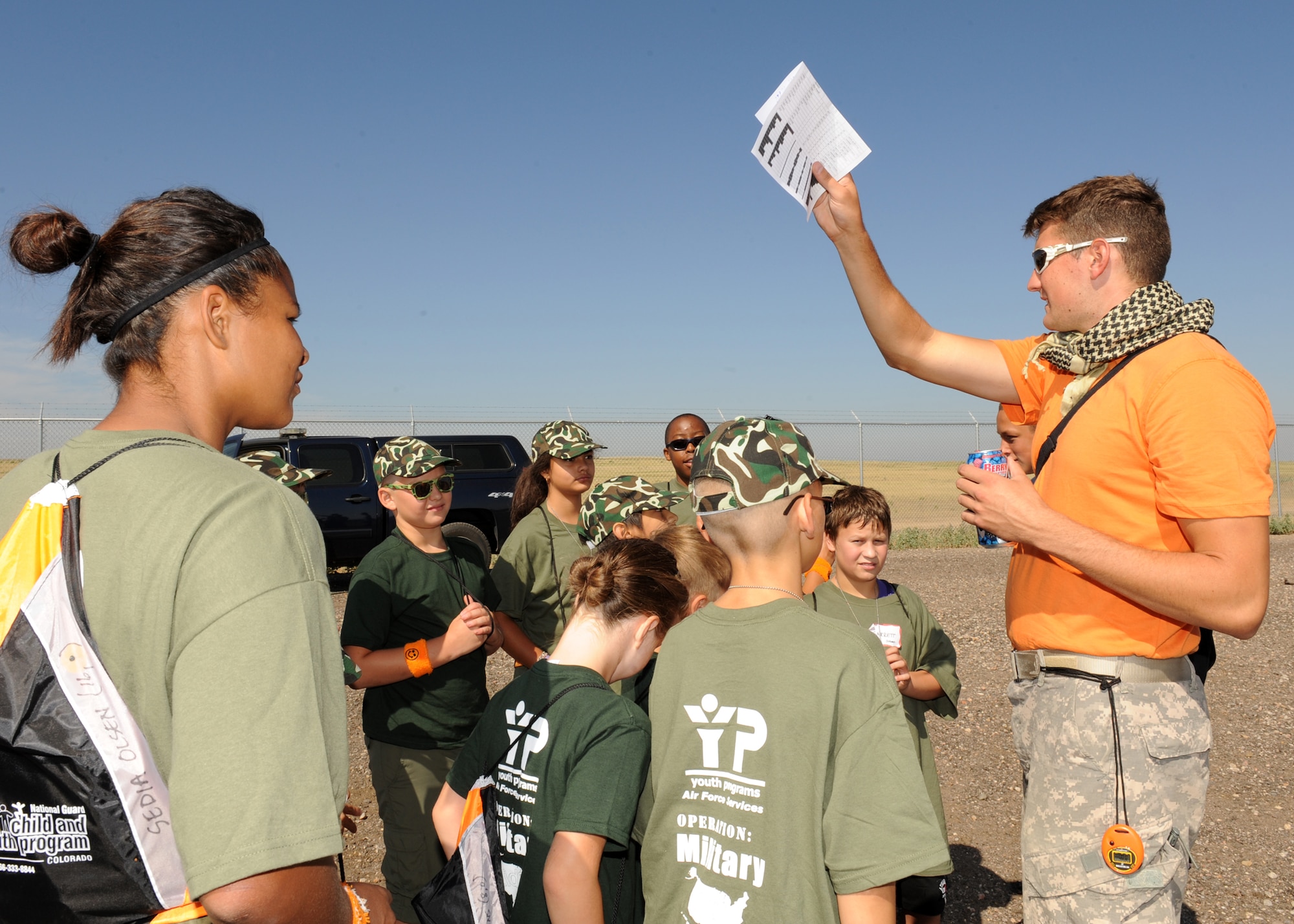 BUCKLEY AIR FORCE BASE, Colo. -- Senior Airman Brian Powell, 460th Contracting Squadron, instructs children on security procedures Aug. 13, 2011. During Operation Future Forces, Team Buckley gave children the chance to experience military life beginning with basic training through deploying. The group deployed to "Bucklistan," during their scenario, where they were given a mission to deliver aid and supplies to civilians in need. (U.S. Air Force photo by Senior Airman Marcy Glass)
