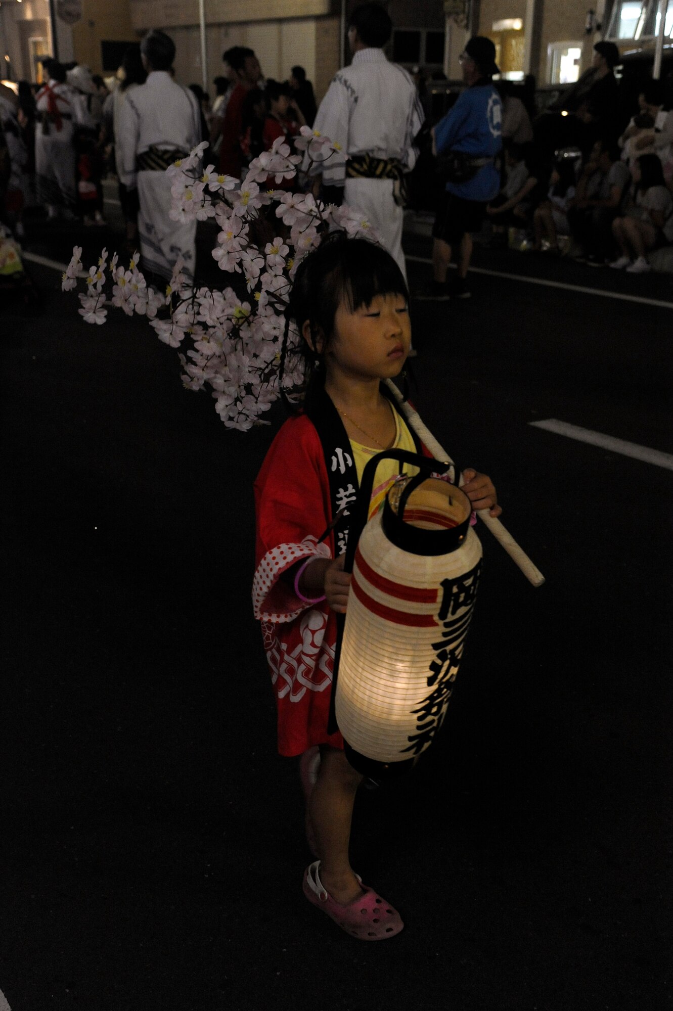 MISAWA CITY, Japan -- A young girl dressed in a traditional Japanese robe walks down the parade route caring a lantern during the annual Misawa Summer Festival Aug. 19. The parade wrapped around the streets of Misawa City passing American Park and heading toward the Civic Center. (U.S. Air Force photo/Tech. Sgt. Marie Brown)