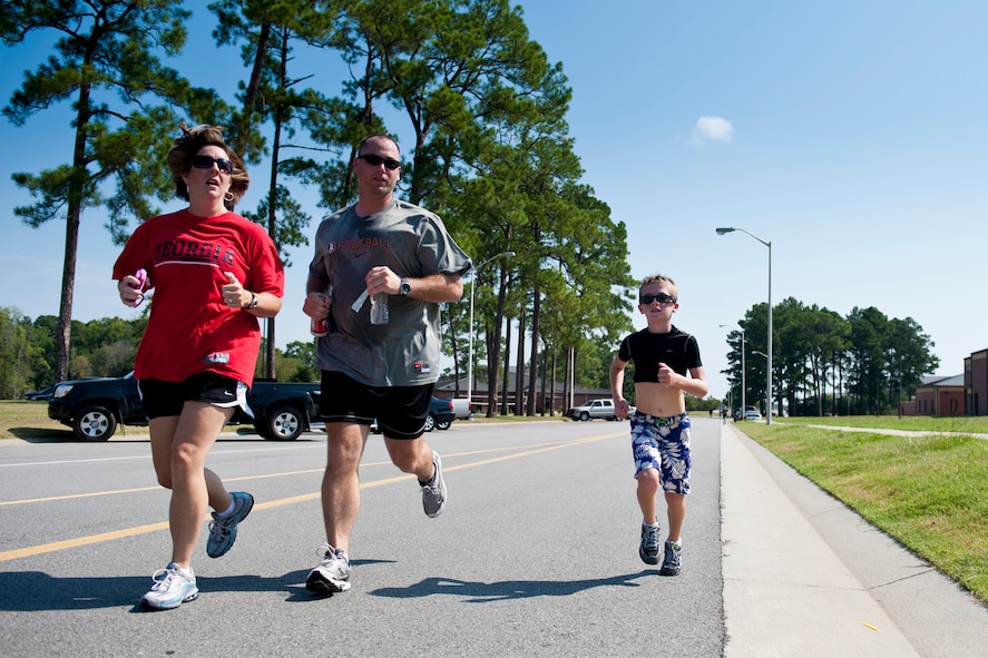 Trevor makes his way to the finish line with his father, U.S. Air Force Master Sgt. Jason Elftmann, and mother, Terri, during the Kids Triathlon at Moody Air Force Base, Ga., Aug. 20, 2011. Parents were encouraged to motivate their children and run along with them during the event. Elftmann is assigned to the 23rd Civil Engineer Squadron. (U.S. Air Force photo by Staff Sgt. Jamal D. Sutter/Released)