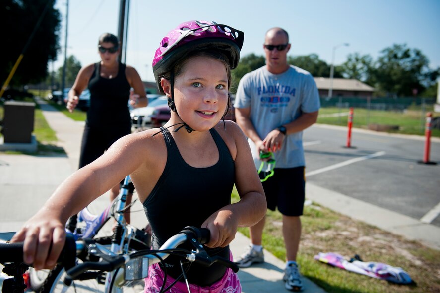 Grace, daughter of U.S. Air Force Capt. Scott Metzler, 93d Air Ground Operations Wing, prepares her bicycle for the second portion of the Kids Triathlon at Moody Air Force Base, Ga., Aug. 20, 2011. This was Moody’s second time hosting the annual event. (U.S. Air Force photo by Staff Sgt. Jamal D. Sutter/Released)