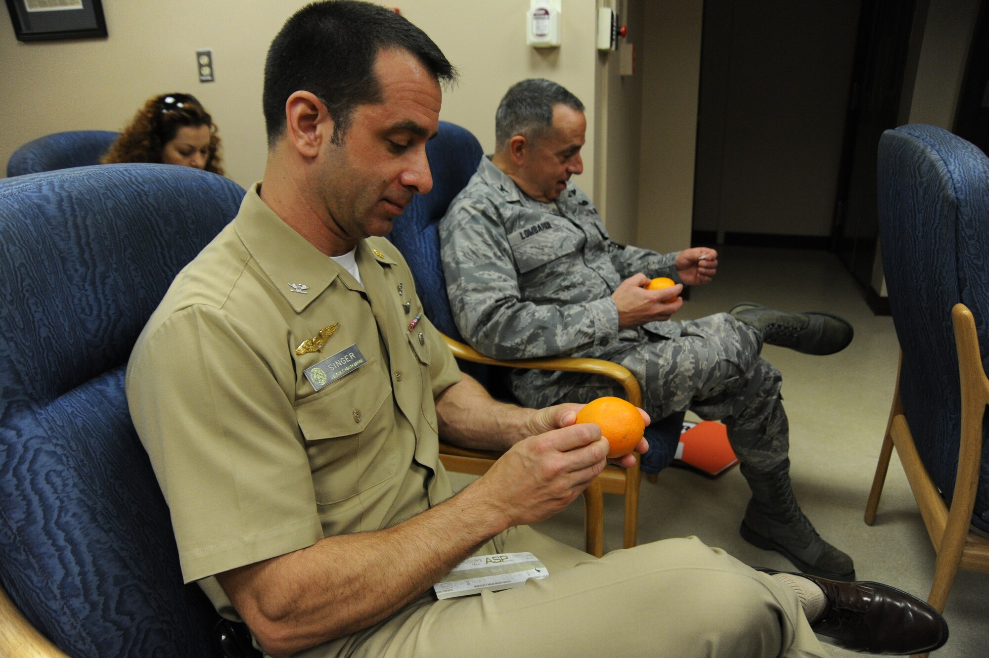 Public Health Service Capt. Darrell Singer Office of the Secretary of Defense with the National Institute of Health from the Pentagon, alongside Col. Sal Lombardi, Joint Force Headquarters Maryland National Guard state surgeon practice placing acupuncture needles into oranges during the battlefield acupuncture course at the Acupuncture Clinic here Aug. 11. . Battlefiled acupuncture is a simple easy to use technique that offers fast and effective pain relief. (U.S Air Force photo/ Bahja J. Jones) 